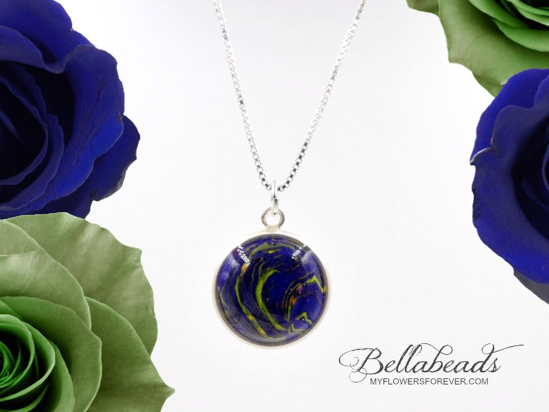 Sterling silver round pendant with a blue and green clay swirled with flowers.
