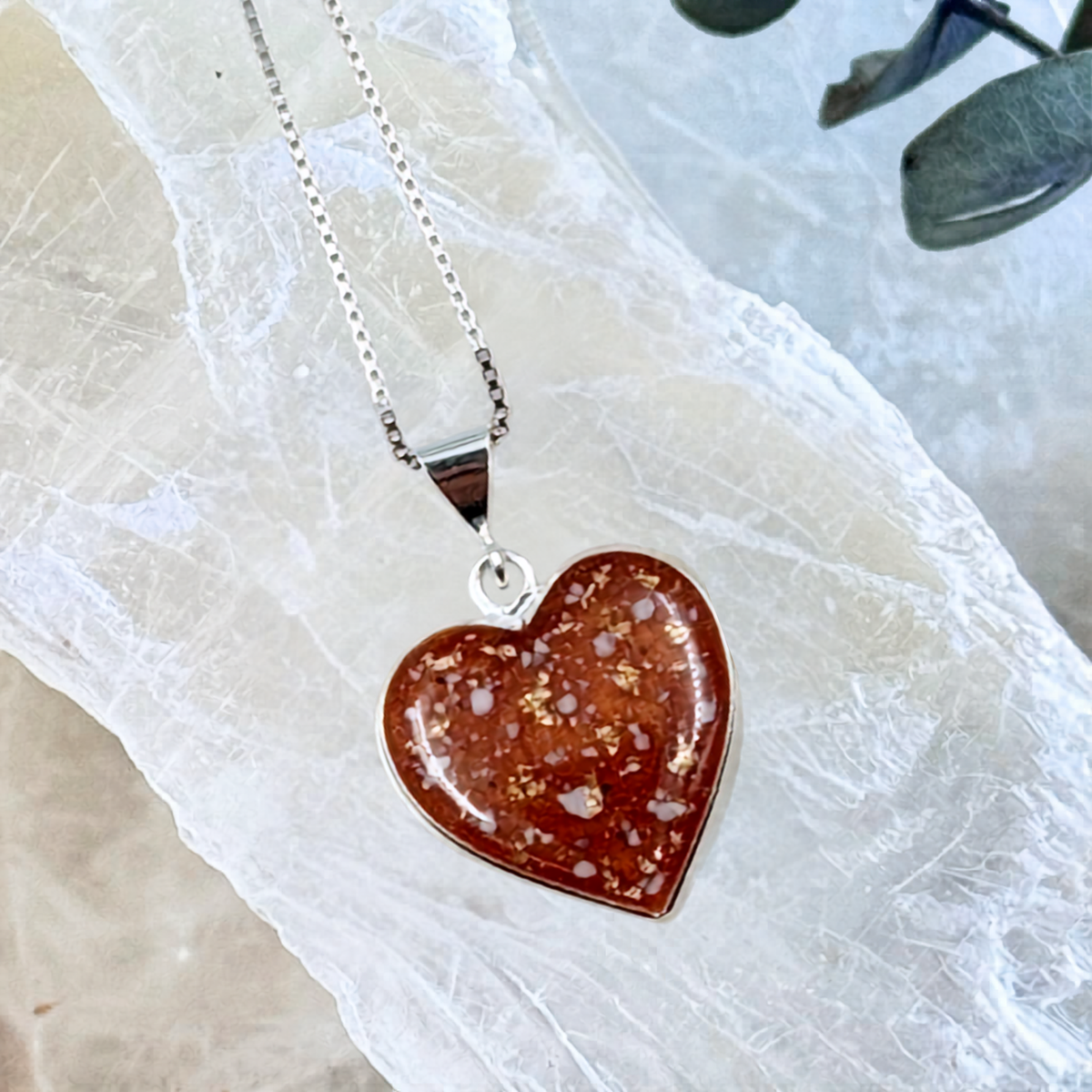 Front view of the Always With Me Heart-Shaped Pet Memorial Ash Pendant handcrafted in sterling silver with cremation ashes, shimmering memorial flakes, and personalized color.