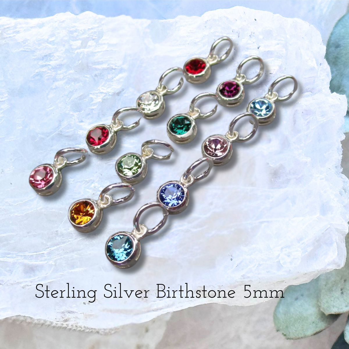 Close-up of a birthstone charm add-on option for the handcrafted Sterling Silver pendant with preserved flowers.