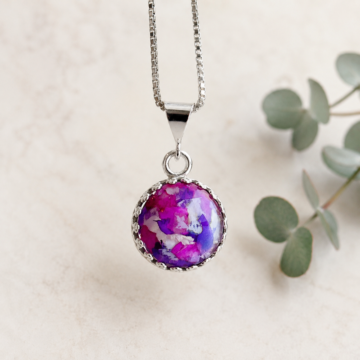 Blossom of Memories 12mm Pendant handcrafted in sterling silver with preserved wedding flowers or funeral flowers, creating a custom memorial keepsake necklace with a round floral design.