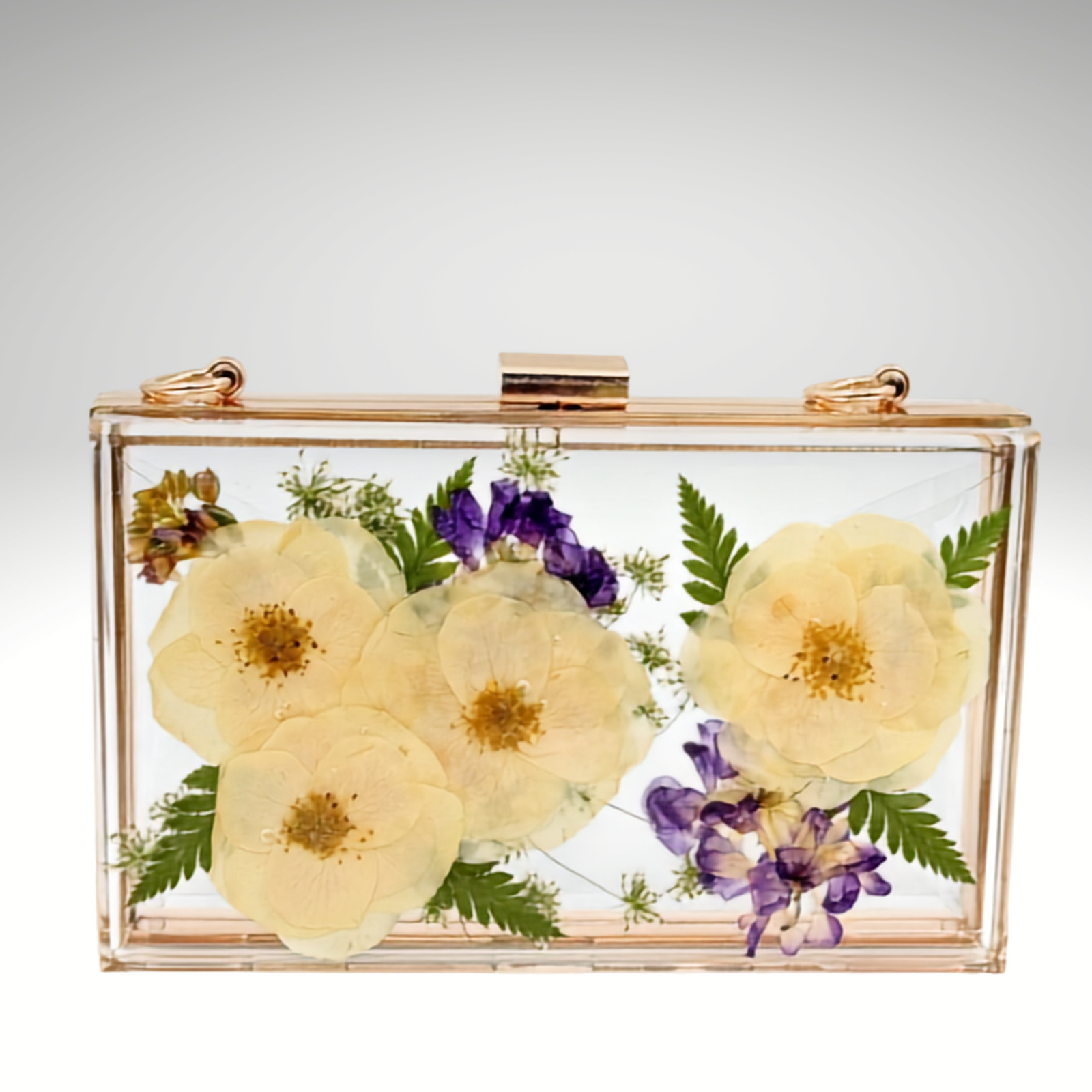 Front view of a custom clear acrylic bridal clutch handcrafted with preserved wedding flowers in resin, featuring ivory roses, purple flowers, and greenery.