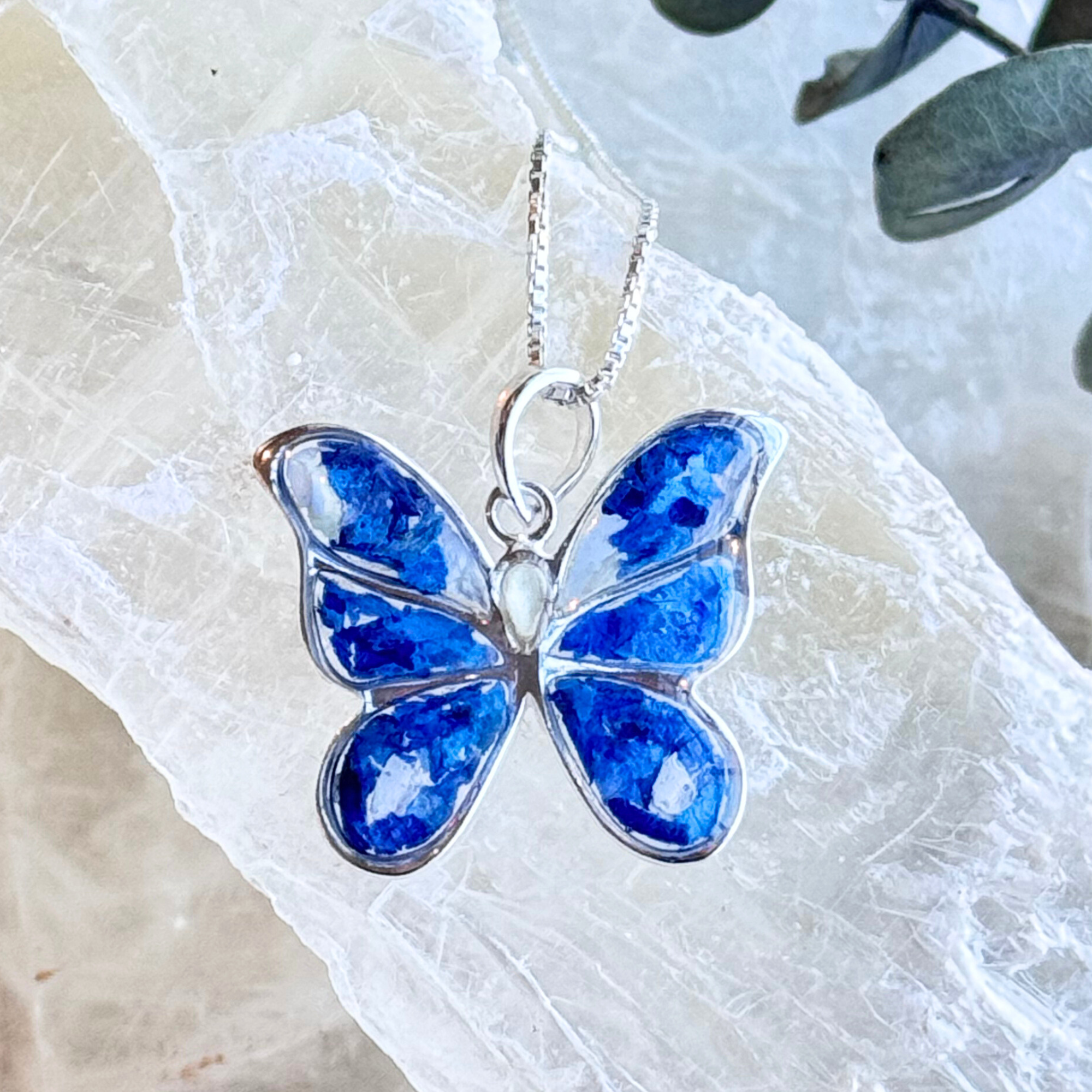 Front view of the Butterfly Keepsake Pendant featuring preserved flowers in a sterling silver butterfly design.