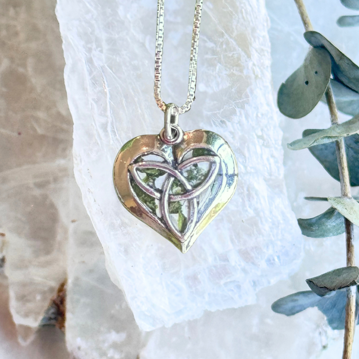 Front view of the Celtic Heart Keepsake Pendant featuring preserved flowers and an intricate sterling silver Celtic knot design.