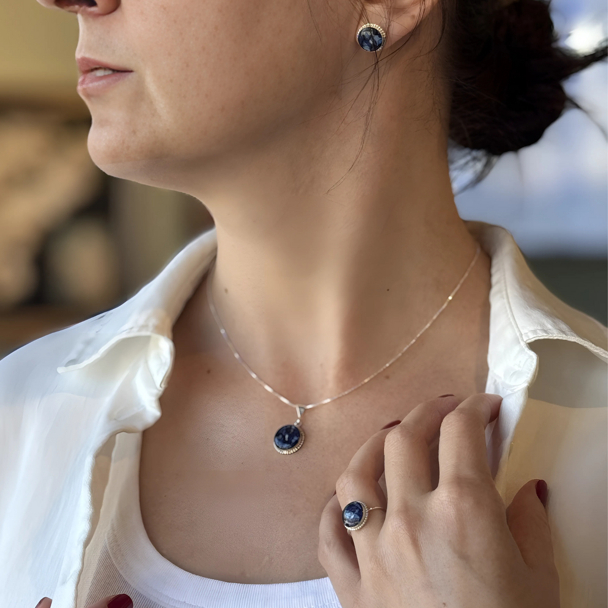 Model wearing the Circle of Memories Pendant, matching ring, and earrings, all crafted with preserved flowers in elegant sterling silver designs.