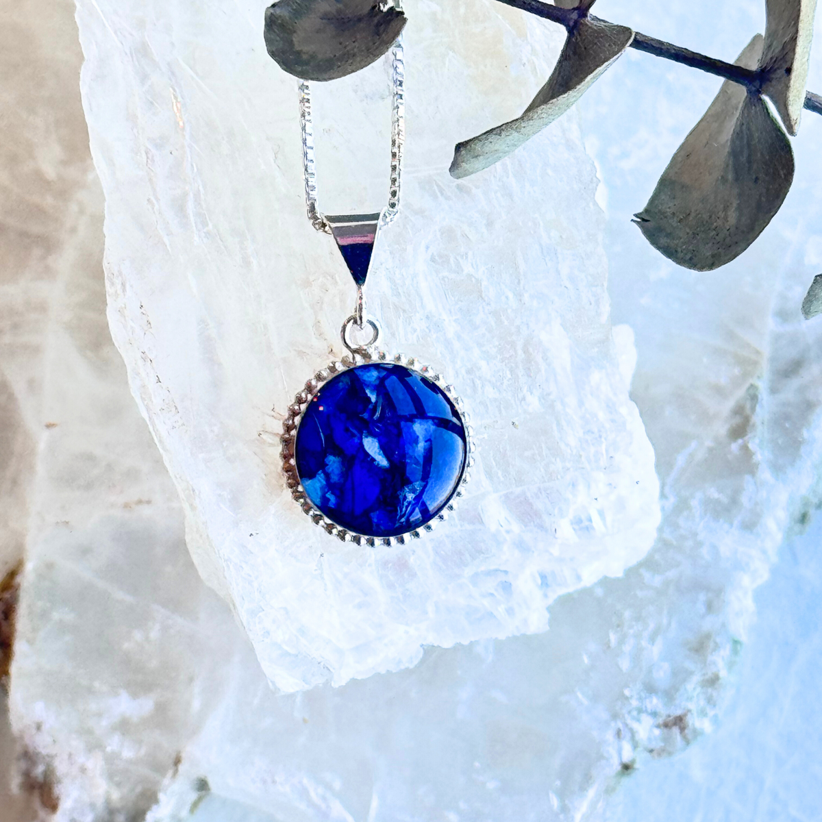 Front view of the Circle of Memories Pendant featuring preserved flowers in an elegant sterling silver round setting.