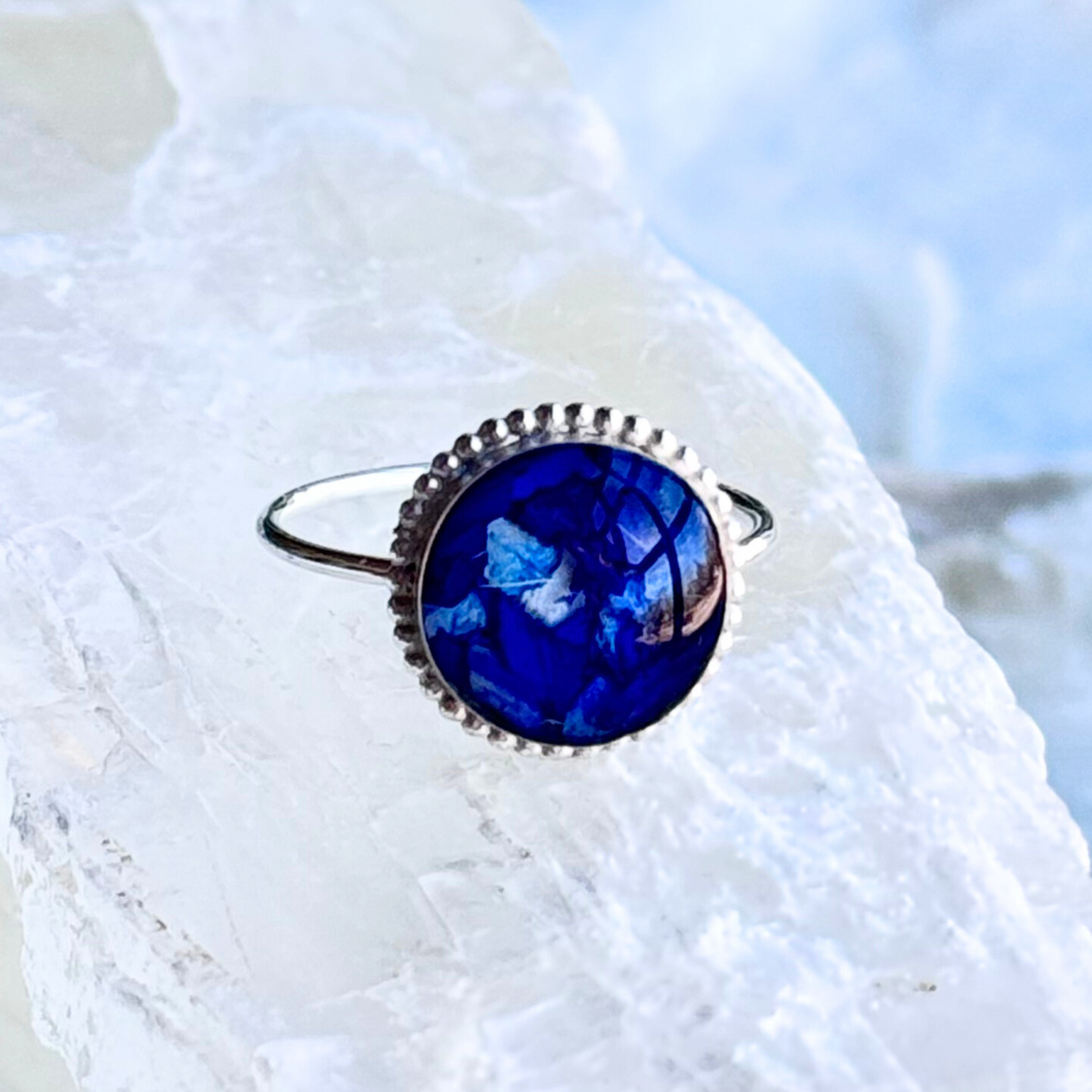 Front view of the Circle of Memories Ring featuring preserved flowers in a sterling silver setting.