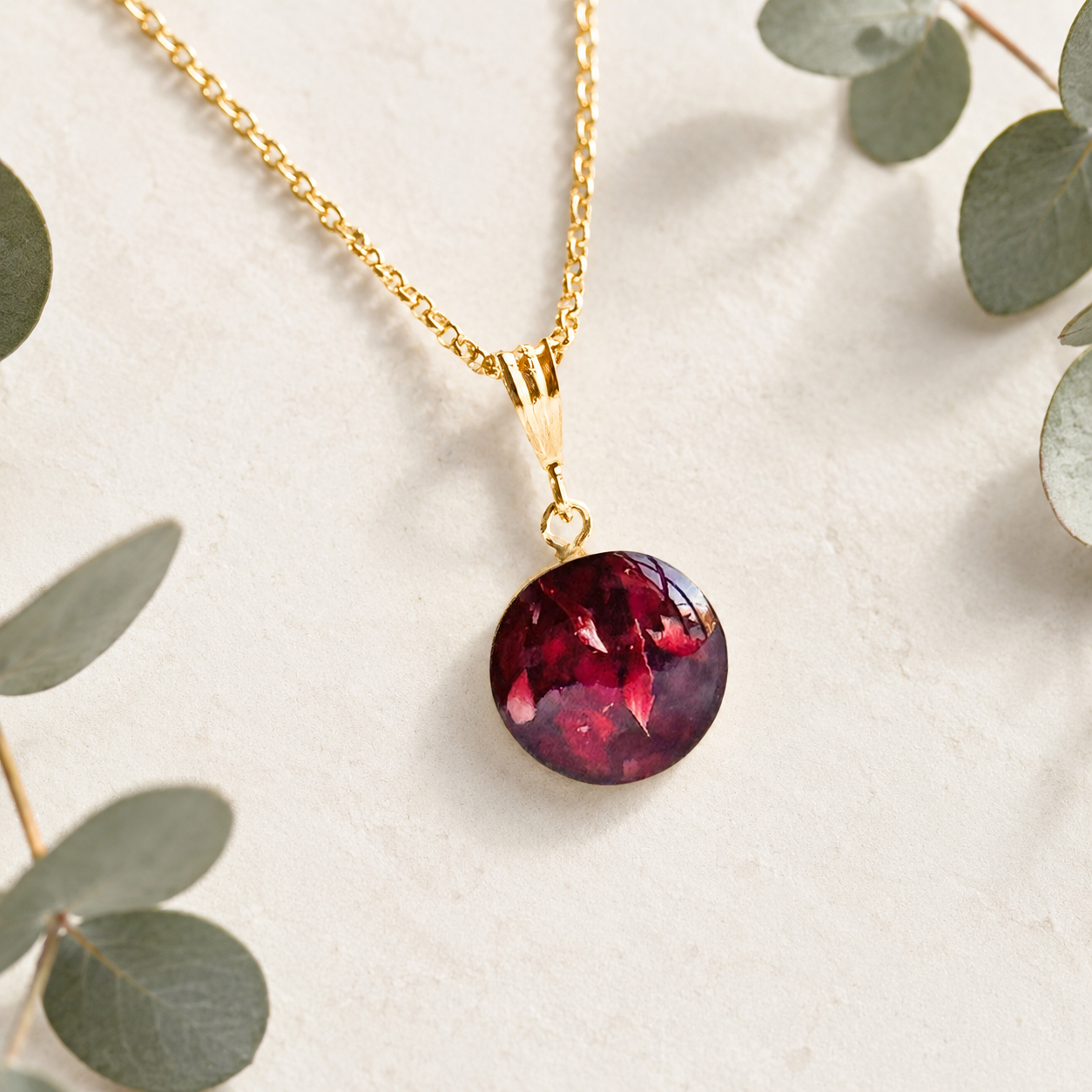 Crown of Memories Pendant in gold handcrafted with preserved deep red wedding flowers, memorial flowers, or funeral flowers in a custom keepsake necklace.