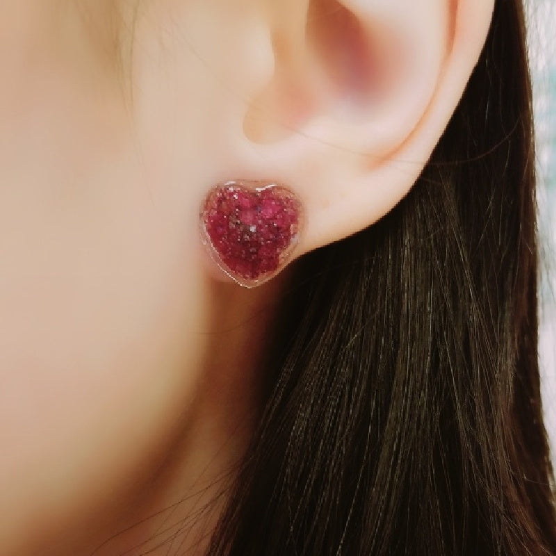 Model wearing Crystal Heart Memorial Posts made with preserved flowers and crystal finish
