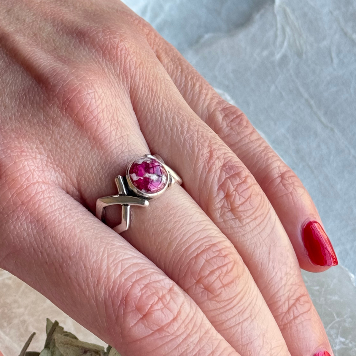 Eternal Memory Ring on a model’s hand, showcasing a custom keepsake made with preserved flowers.