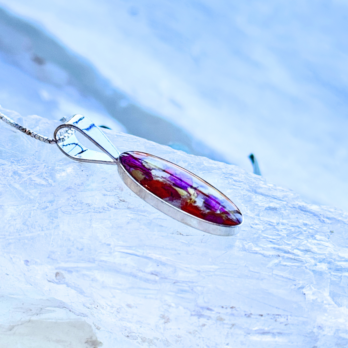 Side view of the Eternal Grace Pendant showcasing the preserved flowers and sterling silver craftsmanship.
