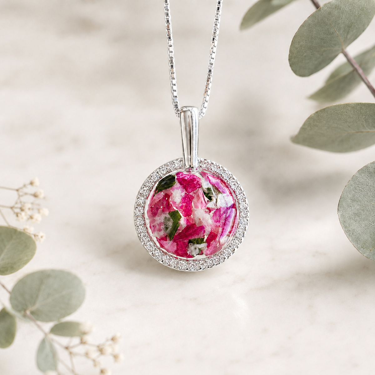 Everlasting Bloom Pendant handcrafted in sterling silver with preserved wedding flowers or funeral flowers, creating a custom memorial keepsake necklace with a sparkling round floral design.