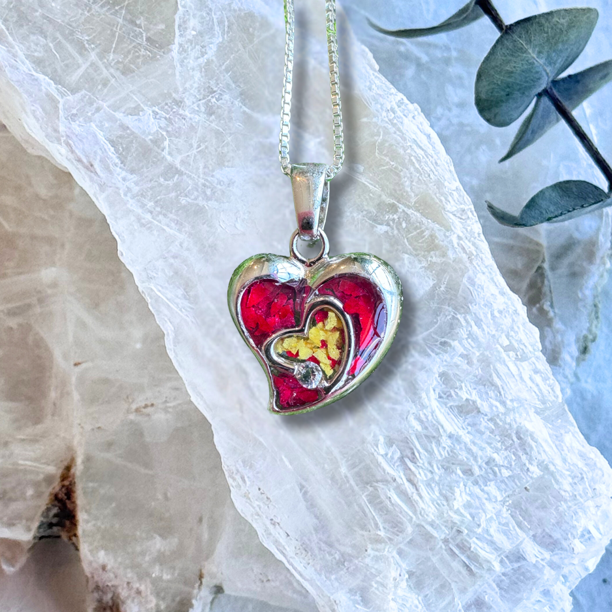 Front view of the Everlasting Heart Pendant featuring preserved flowers in a sterling silver heart-shaped design.