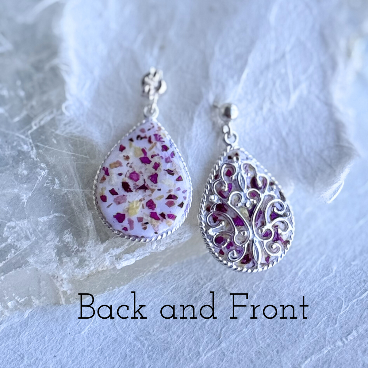 Floral Keepsake Earrings made with preserved flowers, showing detailed scrollwork on the front and smooth silver back
