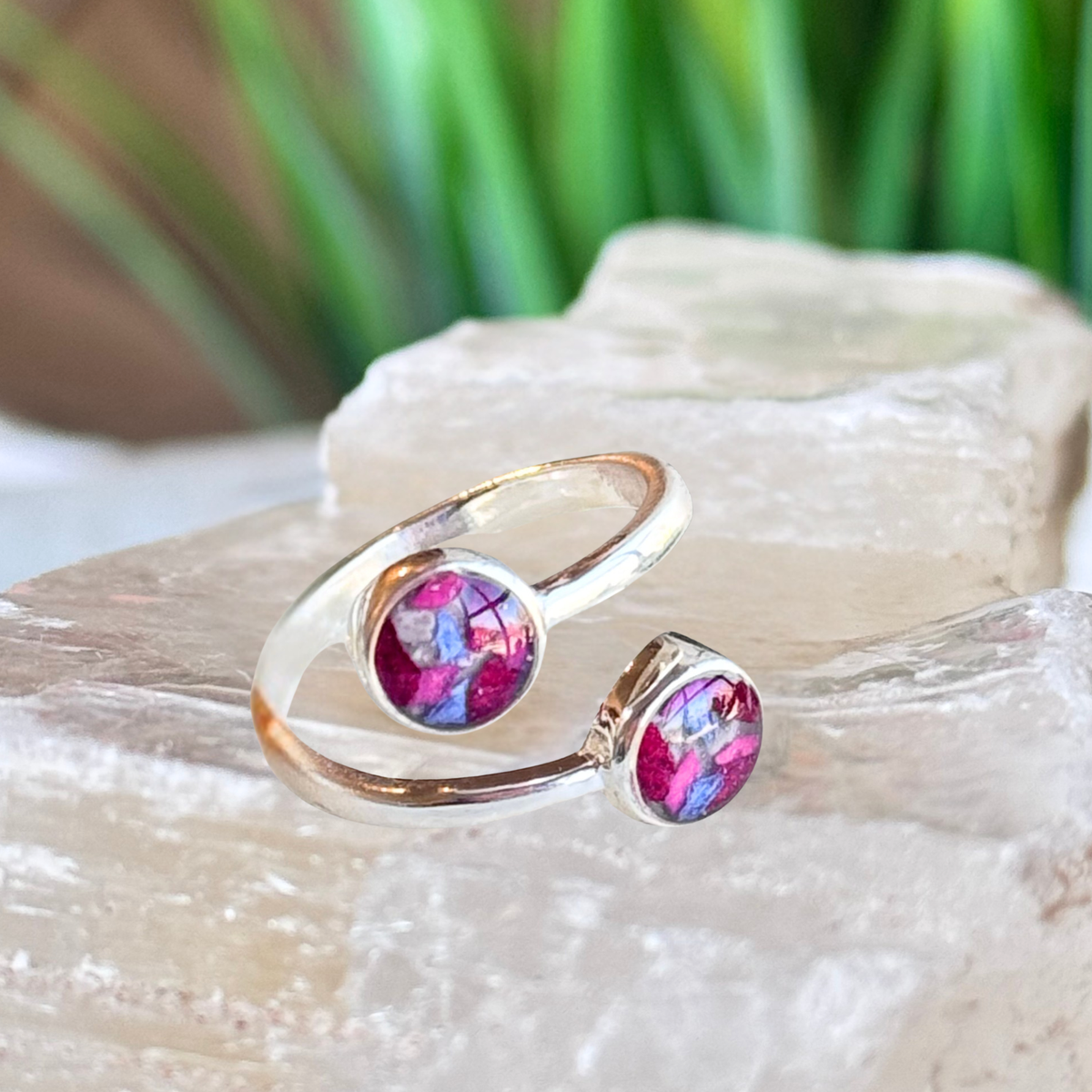 Forever Grace Ring featuring two round keepsake settings handcrafted from preserved flowers or cremation ashes in a modern sterling silver bypass design.