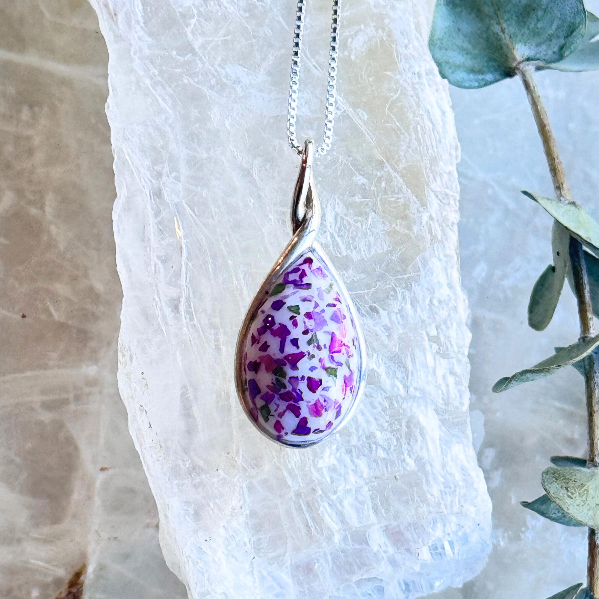 Front view of the Forever Bloom Pendant featuring preserved flowers in a sterling silver teardrop design.