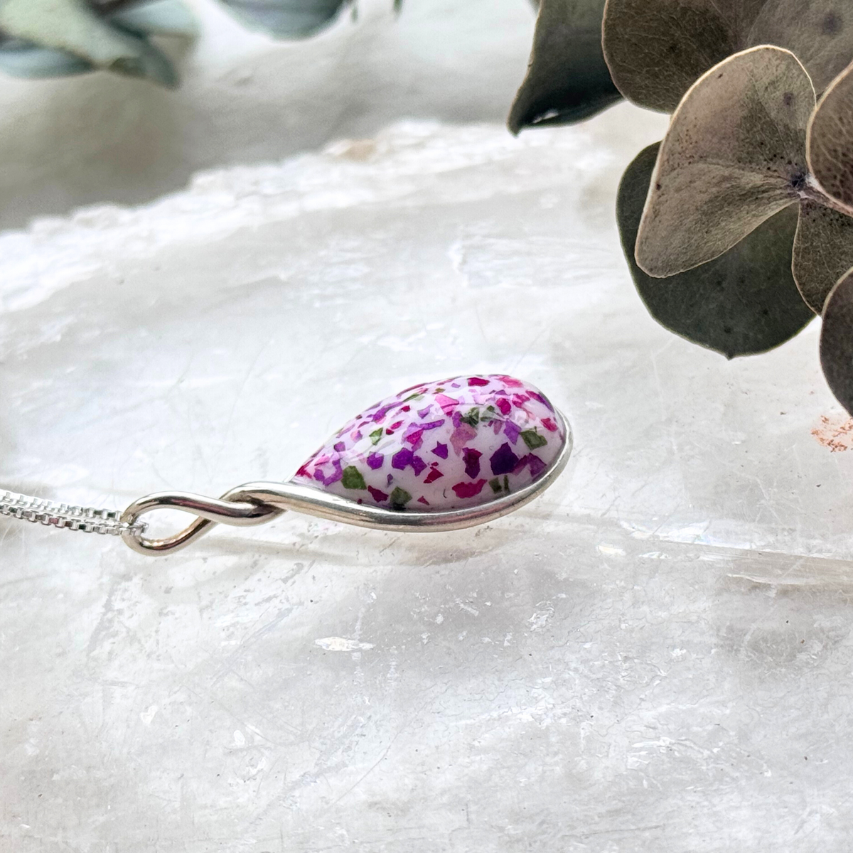 Side view of the Forever Bloom Pendant showcasing the elegant sterling silver frame and preserved flowers.