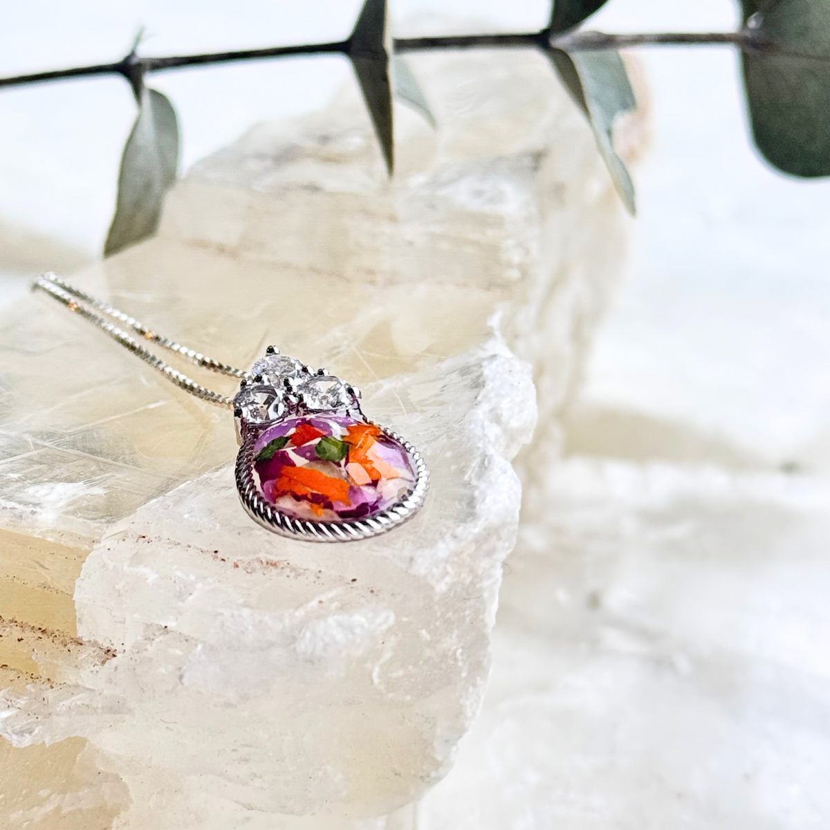 Side view of the Forever in My Heart Pendant featuring preserved funeral flowers