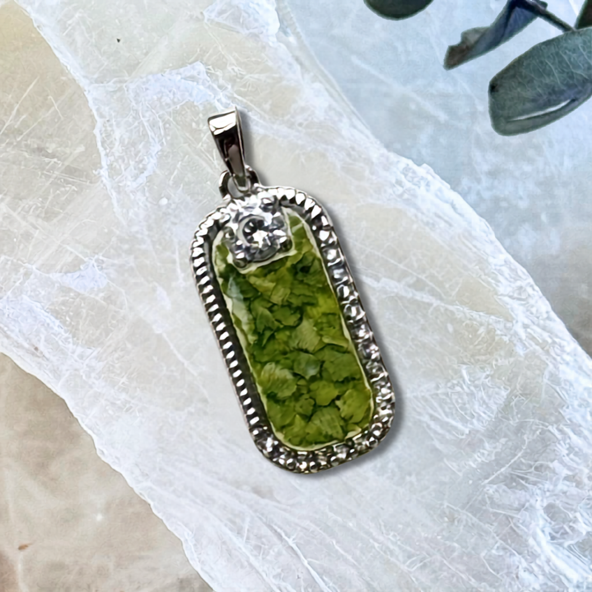 Front view of the Graceful Remembrance Pendant handcrafted with preserved flowers in a sterling silver rectangular setting, creating a meaningful flower preservation memorial keepsake.