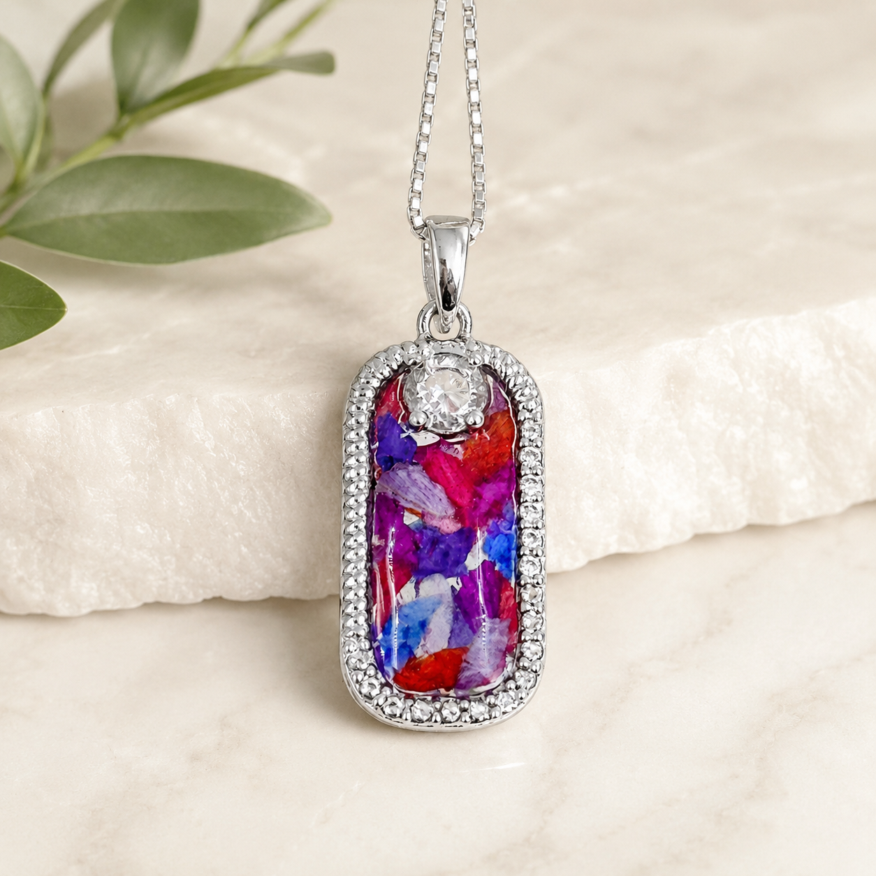 Graceful Remembrance Pendant handcrafted in sterling silver with preserved wedding flowers or funeral flowers, creating a custom memorial keepsake necklace with a sparkling accent stone.