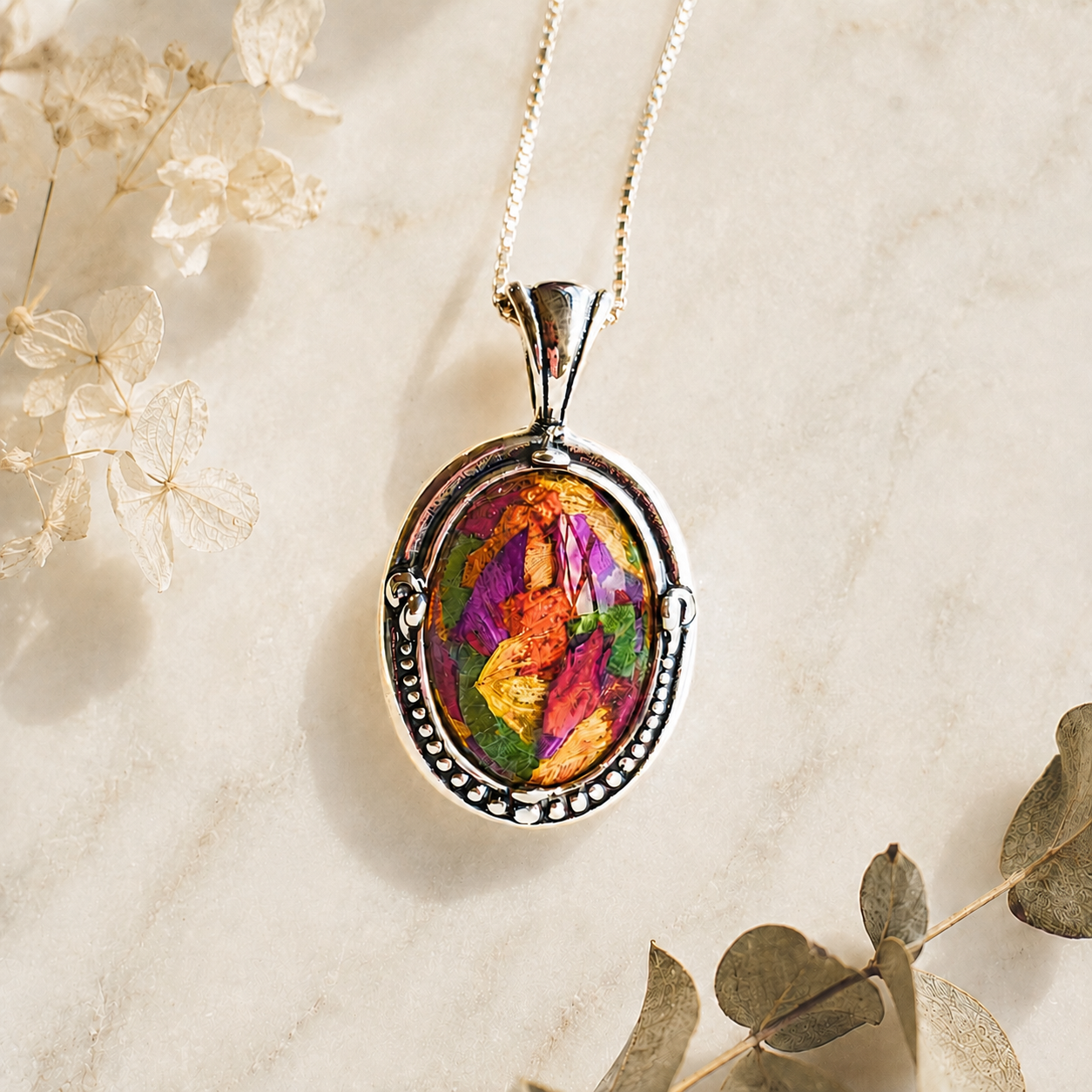 Harmony Oval Pendant handcrafted in sterling silver with preserved wedding flowers or funeral flowers, creating a custom memorial keepsake necklace with real flowers, ashes, or hair.