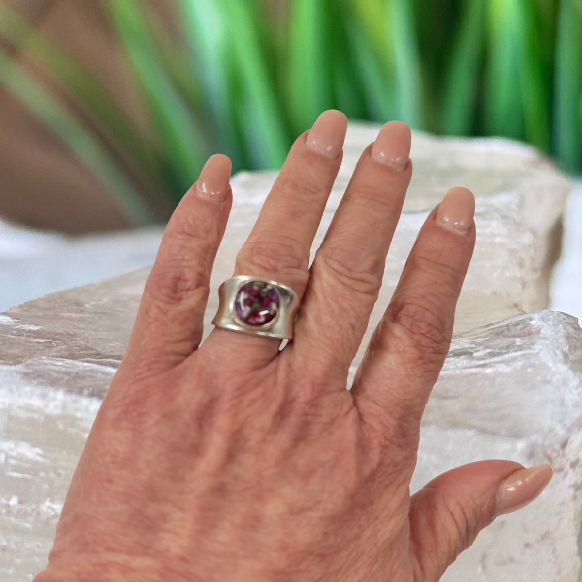 Heritage Keepsake Ring worn on hand, featuring a 10mm round keepsake setting handcrafted from preserved flowers or cremation ashes.