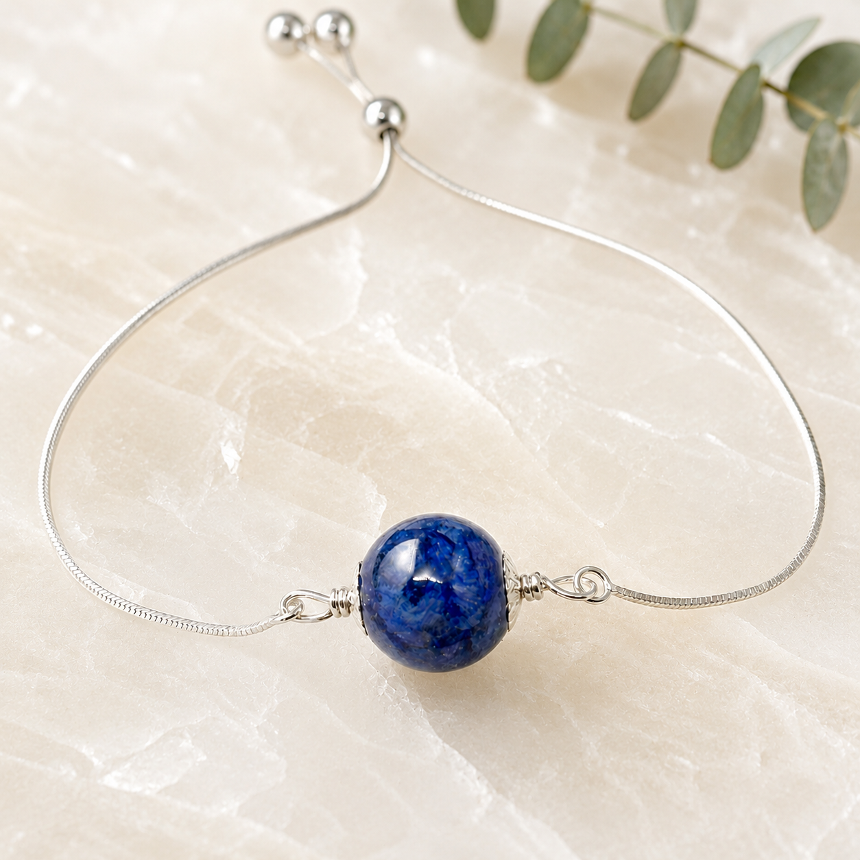 Keepsake Petal Memorial Bracelet handcrafted with real preserved flowers in a sterling silver adjustable slider bracelet. Custom memorial jewelry made with wedding flowers, funeral flowers, ashes, or pet fur.