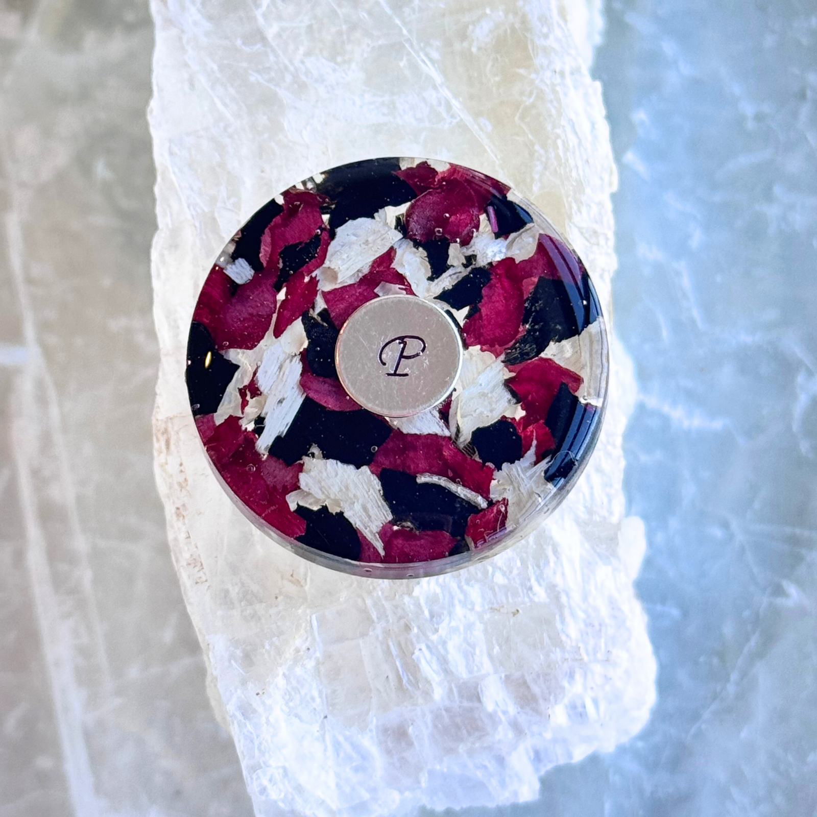 Handcrafted golf ball marker made from preserved memorial flowers