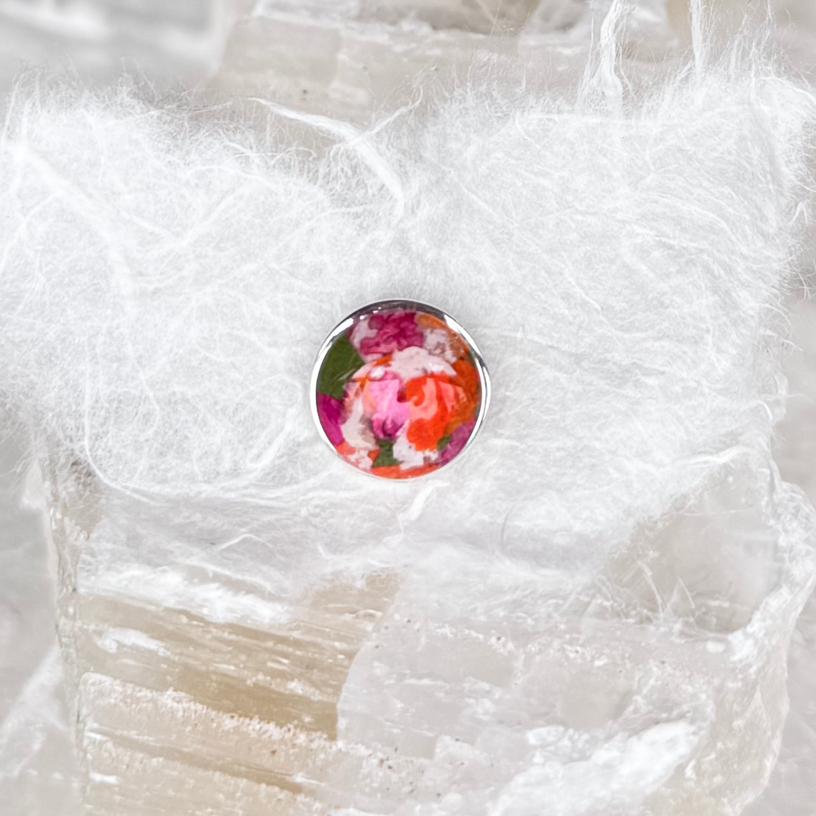 A handcrafted sterling silver memorial tie tac featuring an 11mm floral-infused centerpiece made from preserved funeral flowers.