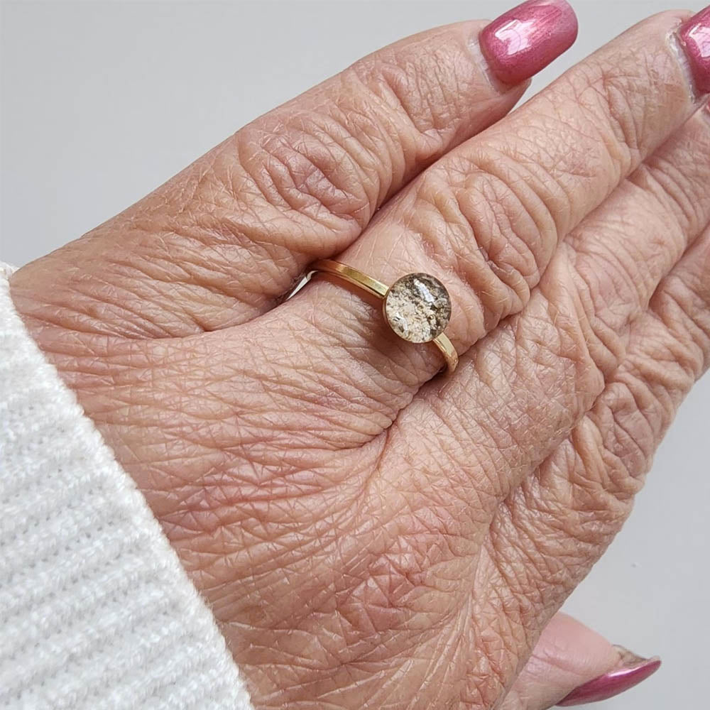 Model wearing the Petite Eternity memorial ring, filled with ashes as a heartfelt keepsake.