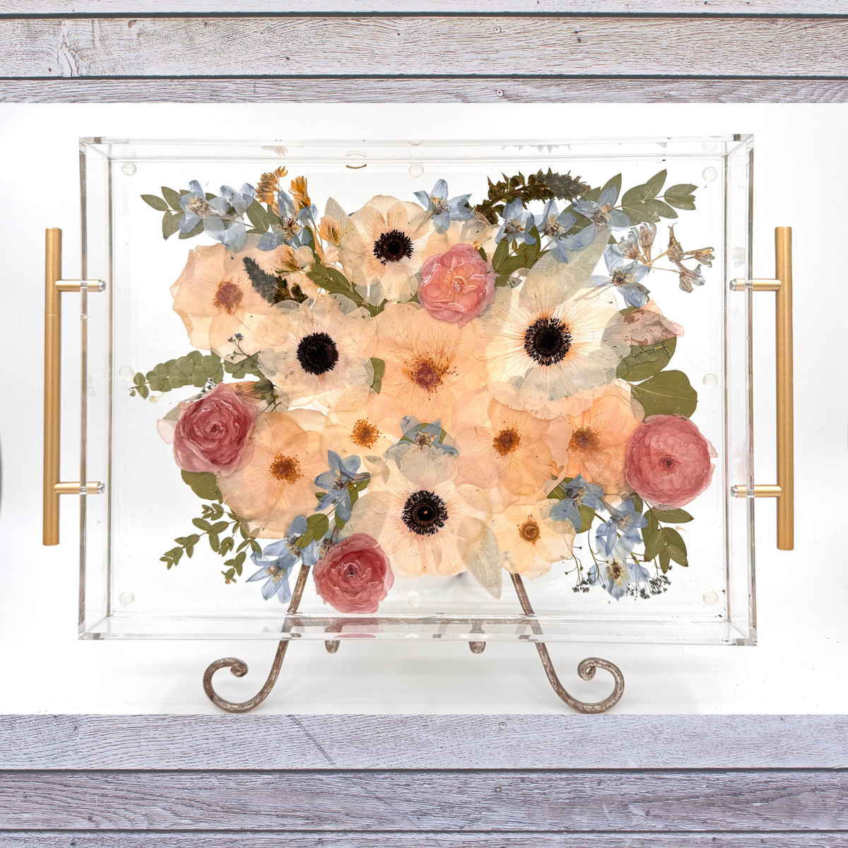 Pressed wedding bouquet flowers preserved under resin in an acrylic tray.