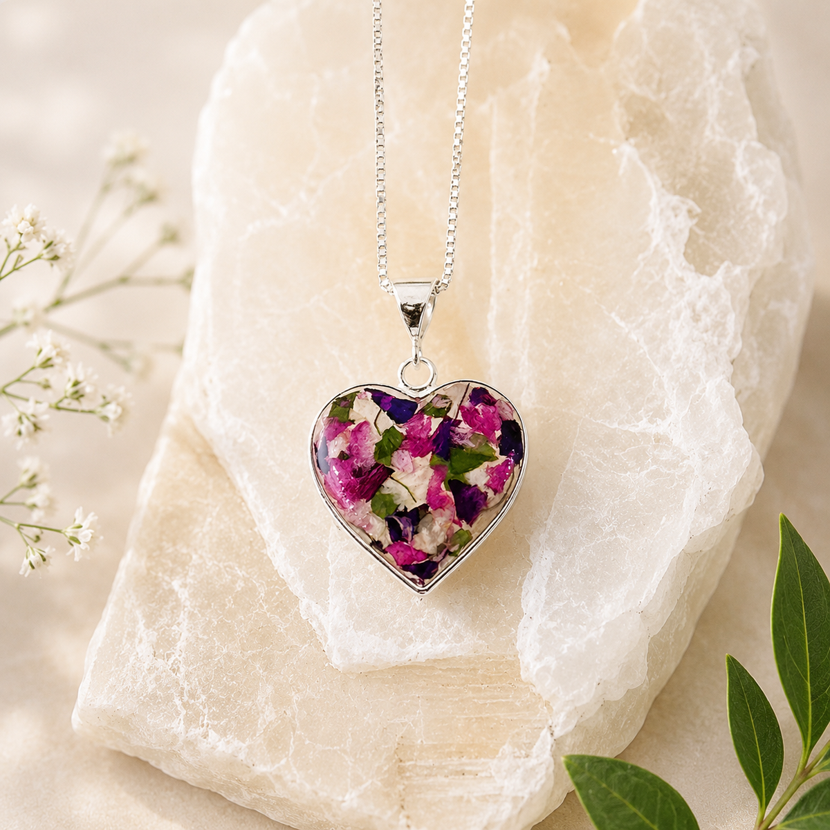 Remembrance Heart Pendant handcrafted with preserved flowers, cremation ashes, or hair in a sterling silver heart memorial necklace, custom made in the USA.