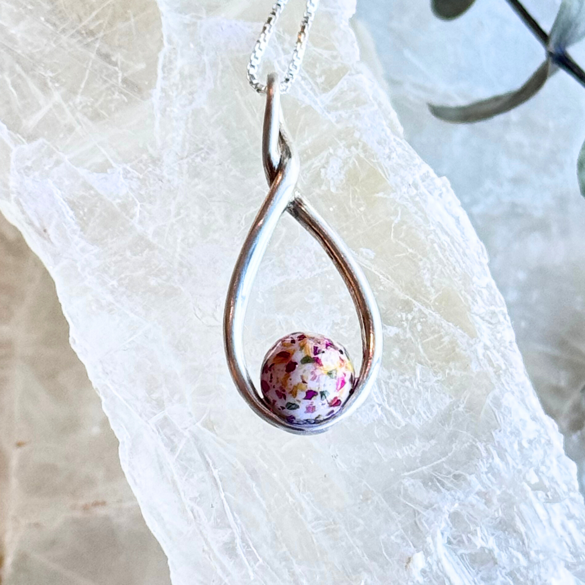 Front view of the Serenity Bloom Pendant, featuring preserved flowers in a sterling silver setting.

