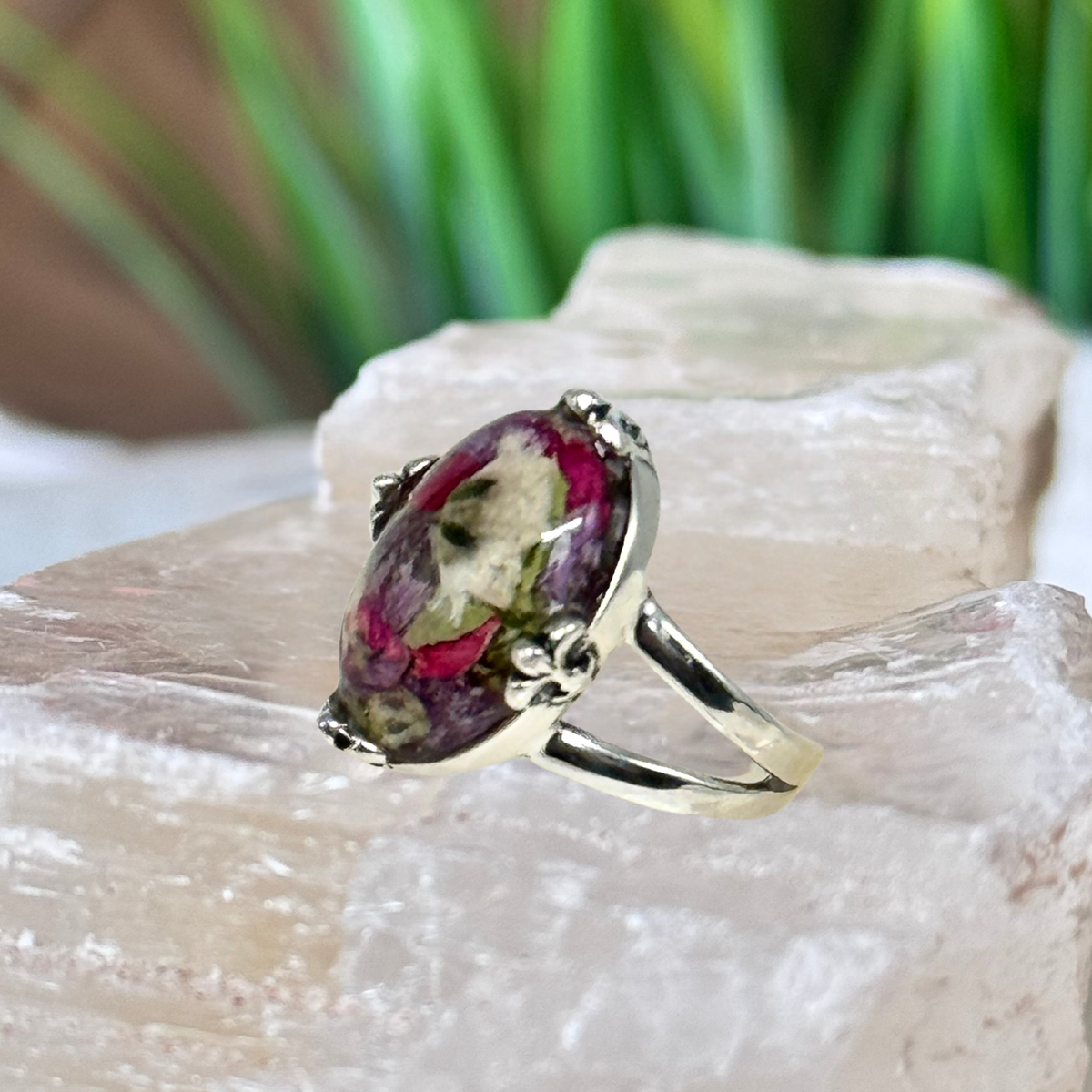 Side view of a handcrafted sterling silver memorial flower ring made with preserved funeral flowers, showing the band profile and square bezel design.