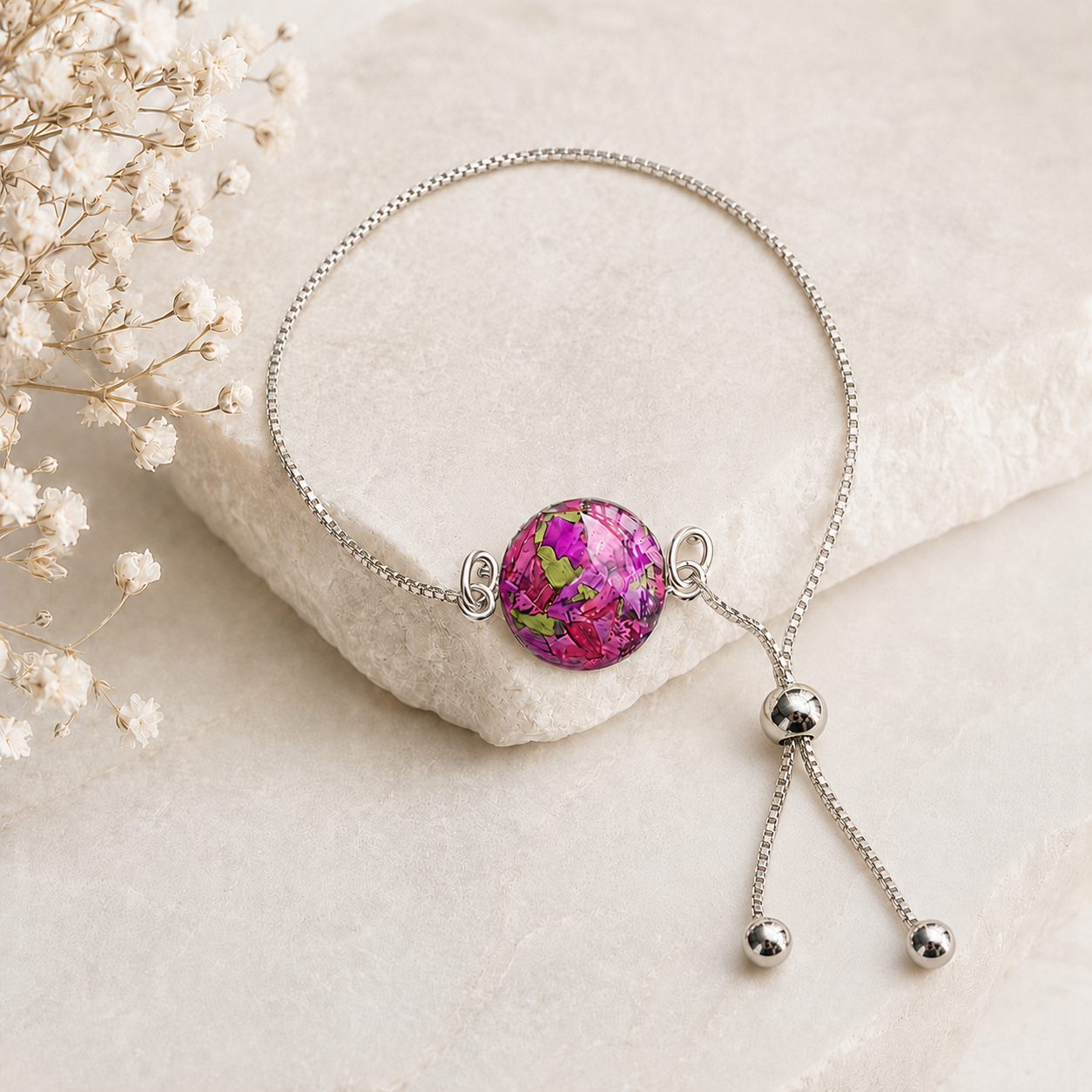 Timeless Blossom Bracelet handcrafted in sterling silver with a preserved flower centerpiece and adjustable slider chain. Custom memorial bracelet made with wedding flowers, funeral flowers, ashes, or pet fur.