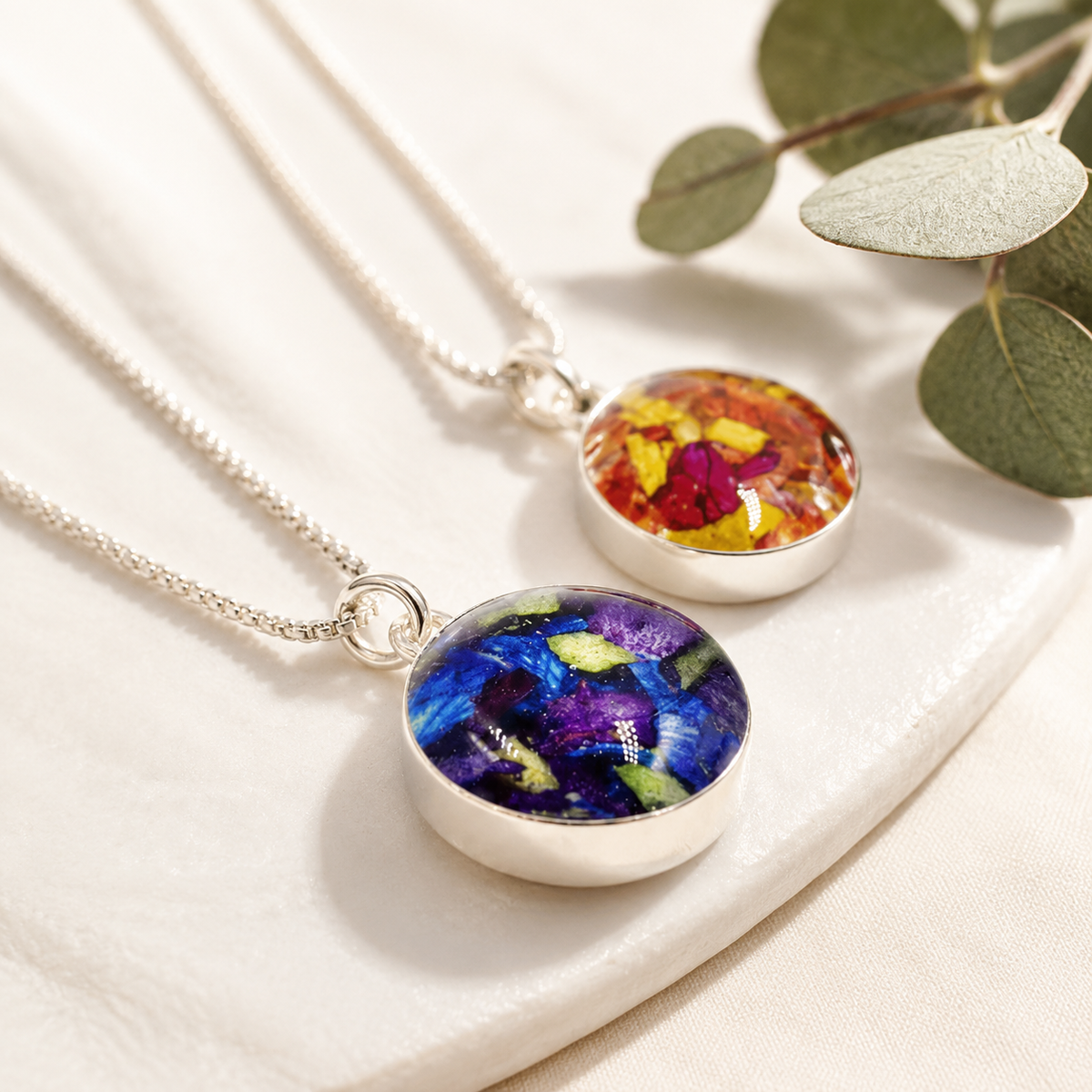 Two Timeless Blossom Pendants handcrafted with preserved wedding flowers, memorial flowers, or funeral flowers in sterling silver custom keepsake necklaces.