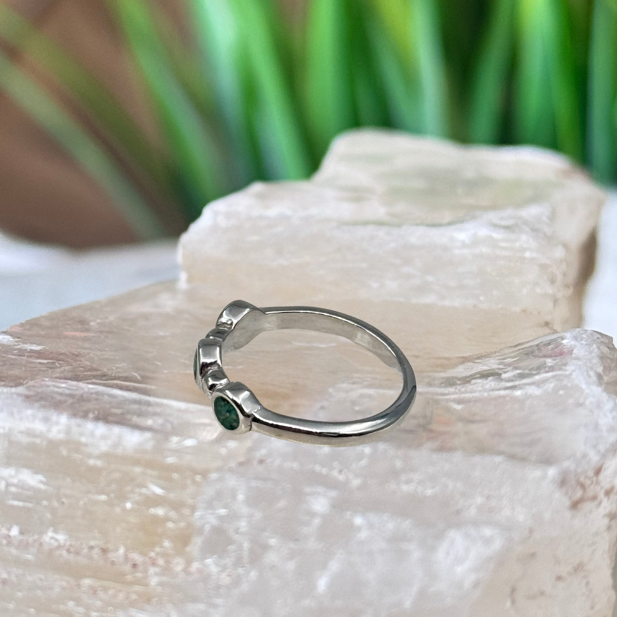 Side view of the Trinity Keepsake Ring showing three 3mm ash keepsake settings in a sterling silver band.