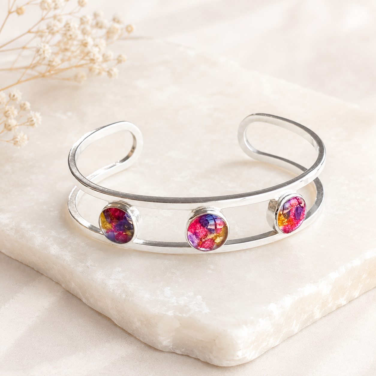 Trinity Memorial Bracelet handcrafted in sterling silver with three preserved flower keepsakes. Custom memorial cuff bracelet made with wedding flowers, funeral flowers, ashes, or pet fur.