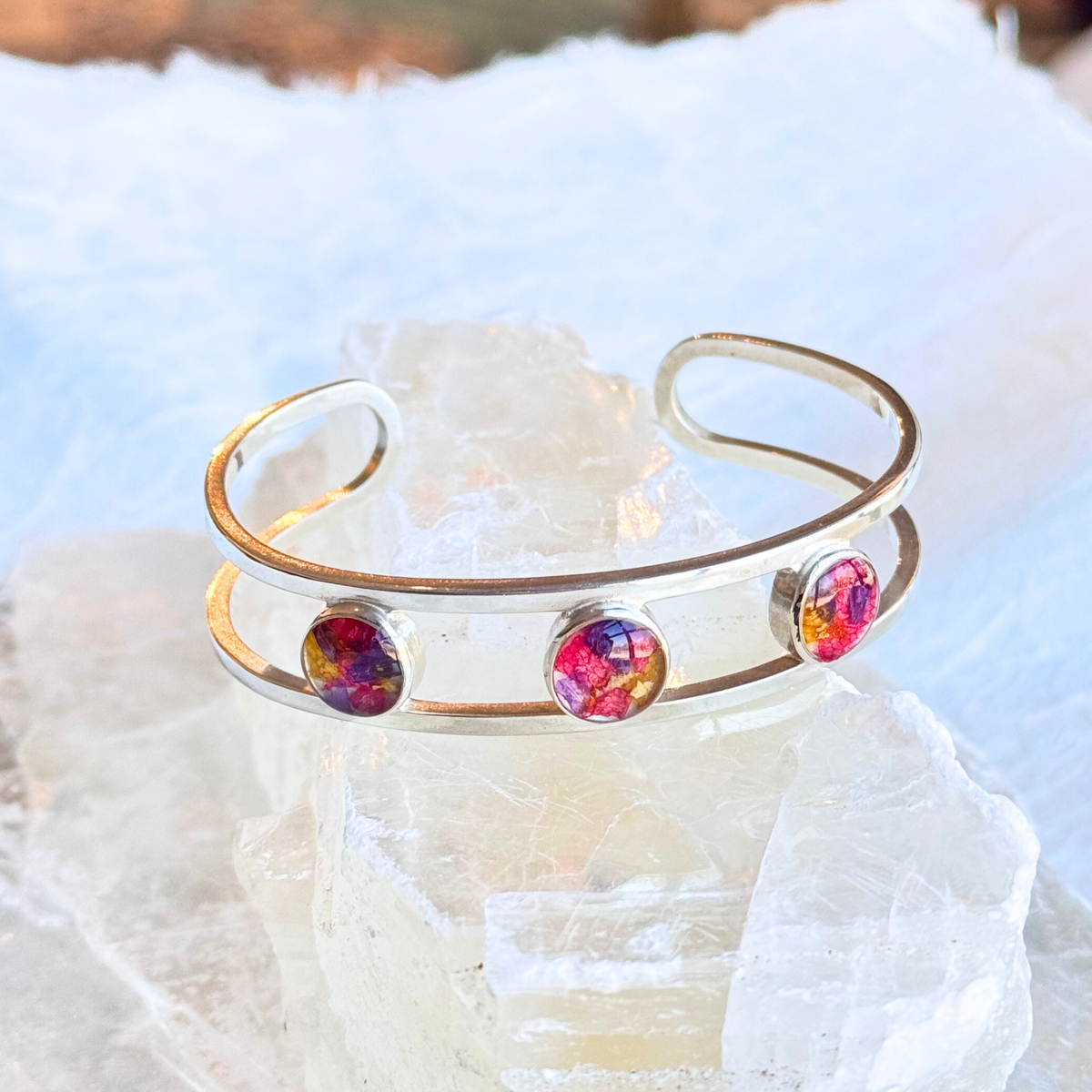 A sterling silver Trinity Memorial Bracelet featuring three flower-infused beads, symbolizing love, memory, and connection.