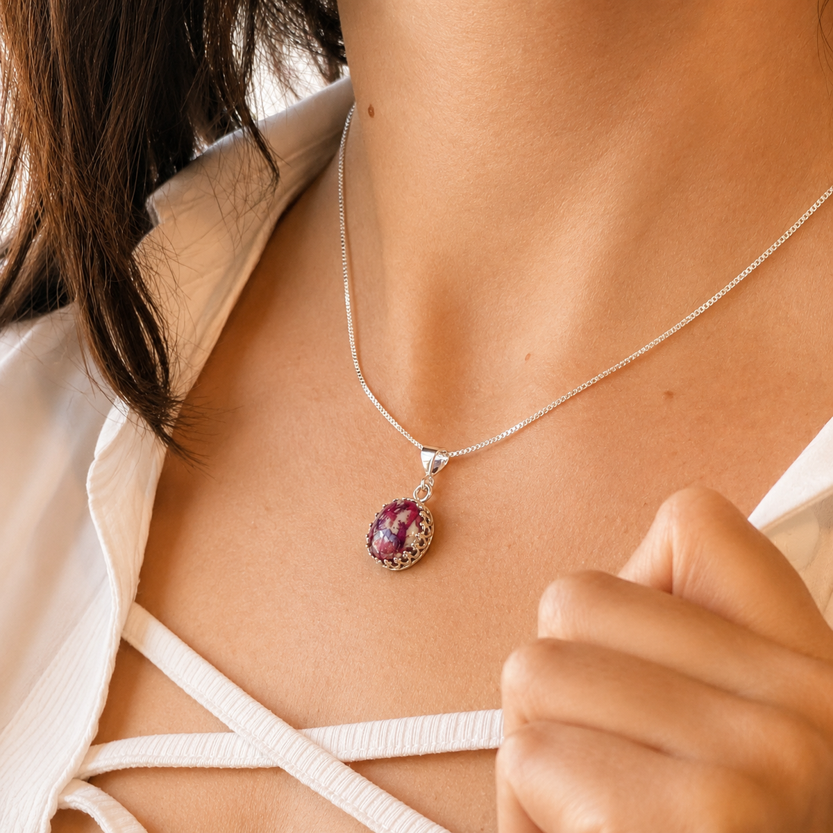 Model wearing Blossom of Memories Pendant with purple and white preserved flowers.