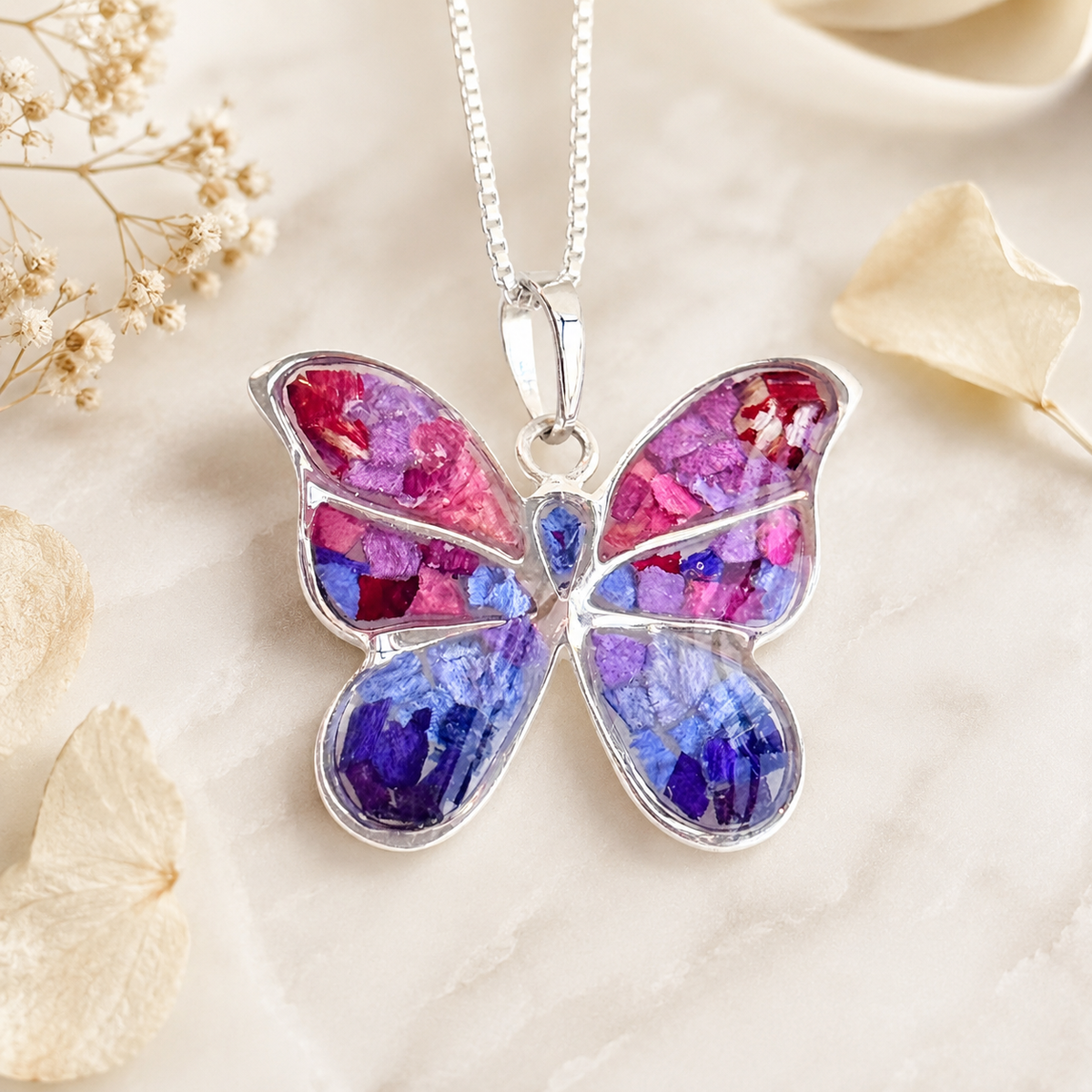 Butterfly Keepsake Pendant handcrafted with preserved wedding flowers, memorial flowers, or funeral flowers in a sterling silver butterfly memorial necklace.