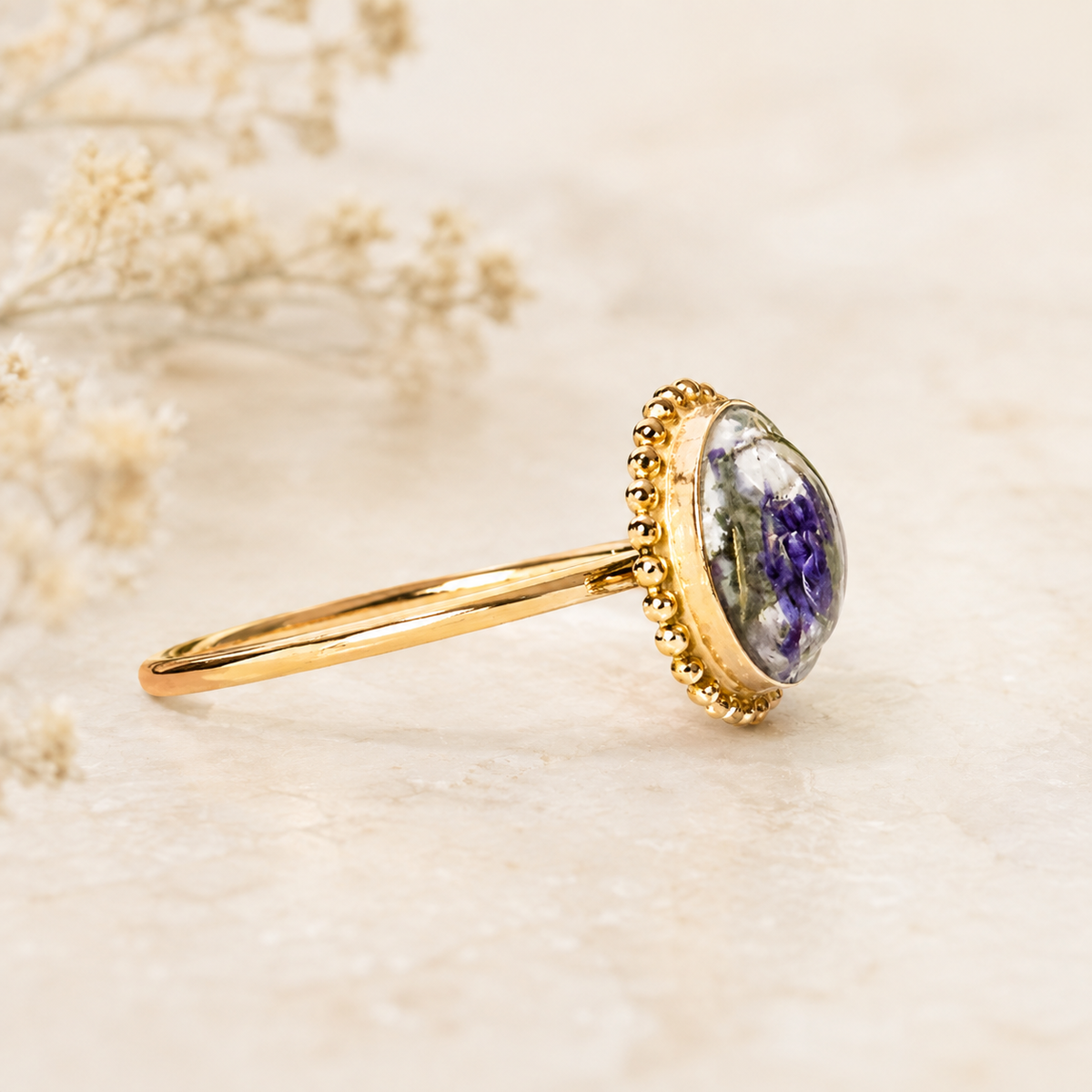 Circle of Memories Ring with purple and white preserved flowers shown from the side.