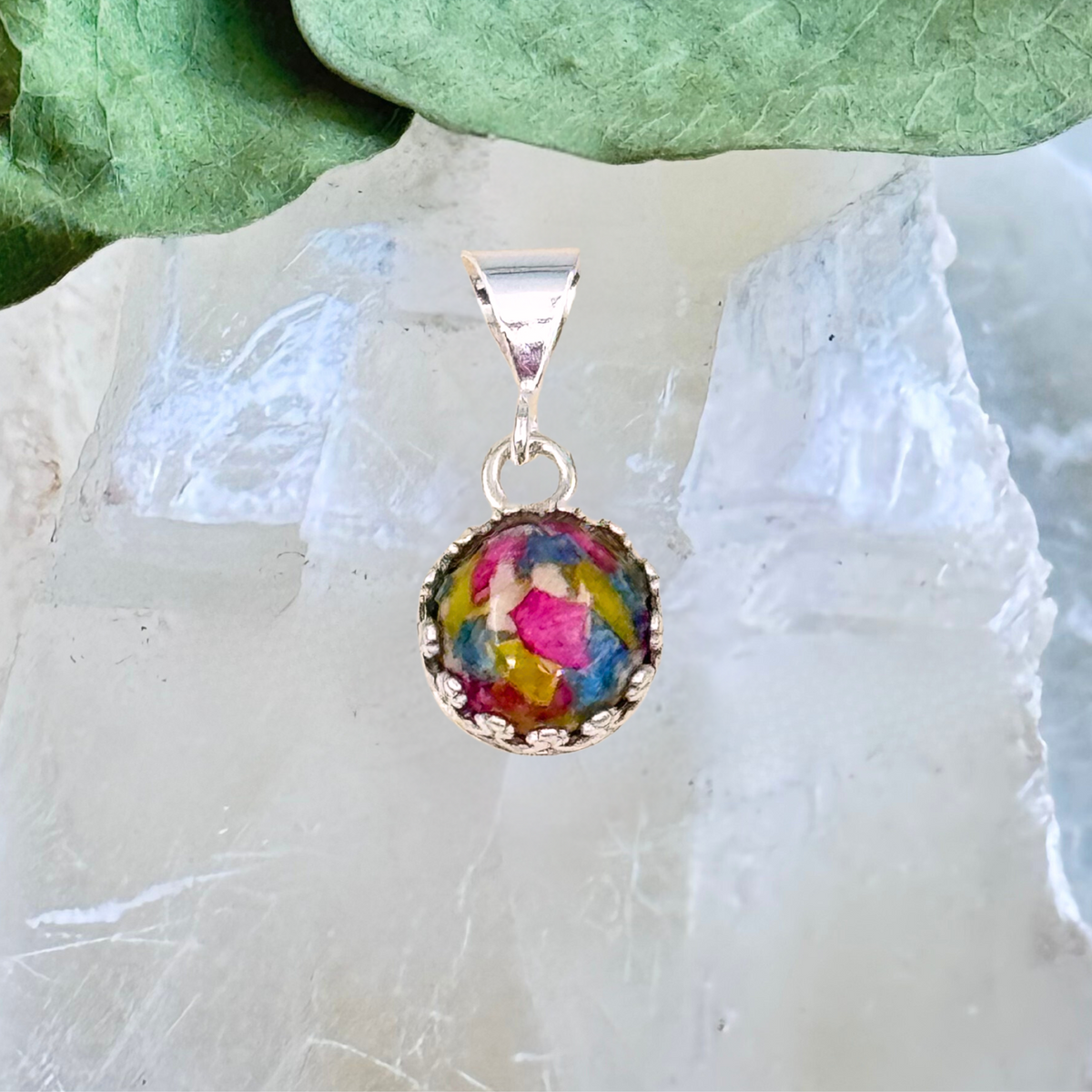 Round sterling silver pendant with colorful preserved flower petals in resin, handmade keepsake necklace from wedding or memorial bouquet

