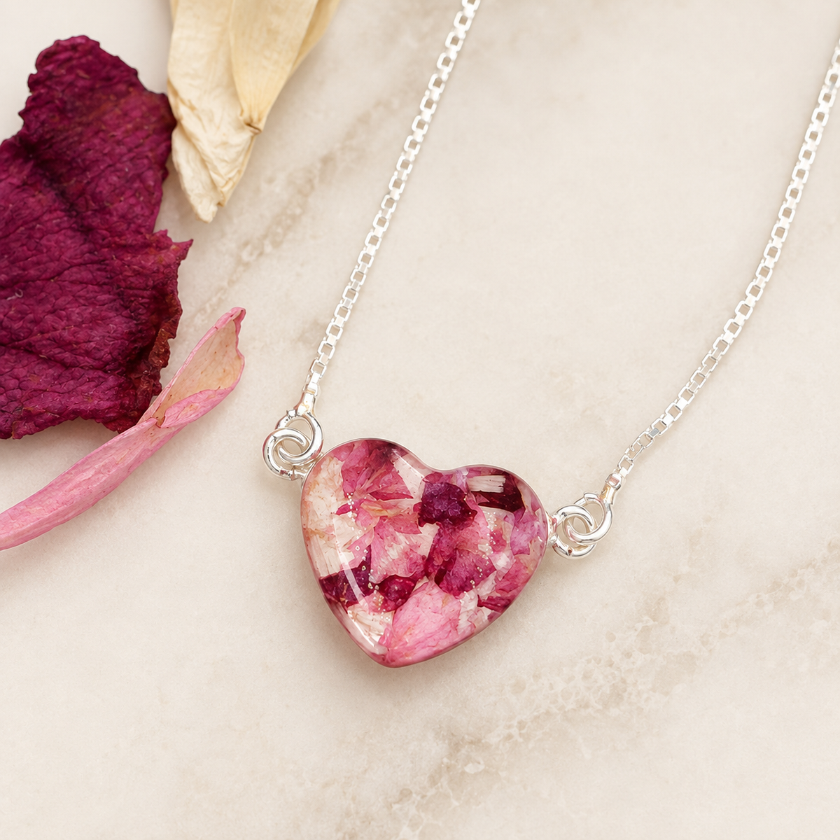 Demi Heart Memorial Bracelet with pink preserved flowers in a heart-shaped setting.