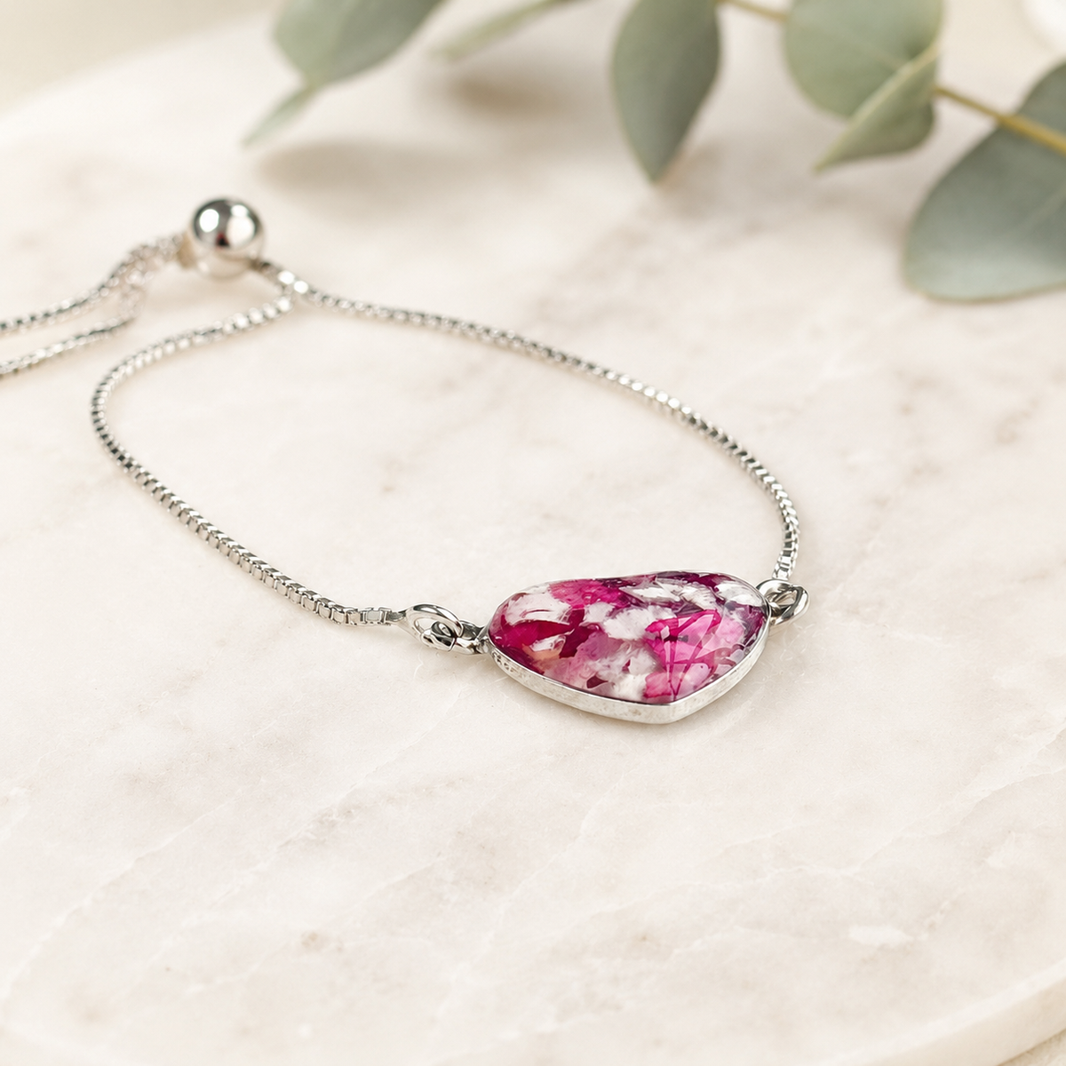 Demi Heart Memorial Bracelet with pink and white preserved flowers shown from the side.