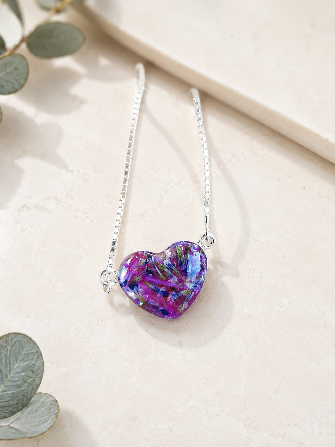 Demi Heart Memorial Bracelet with purple, blue and green preserved flowers.