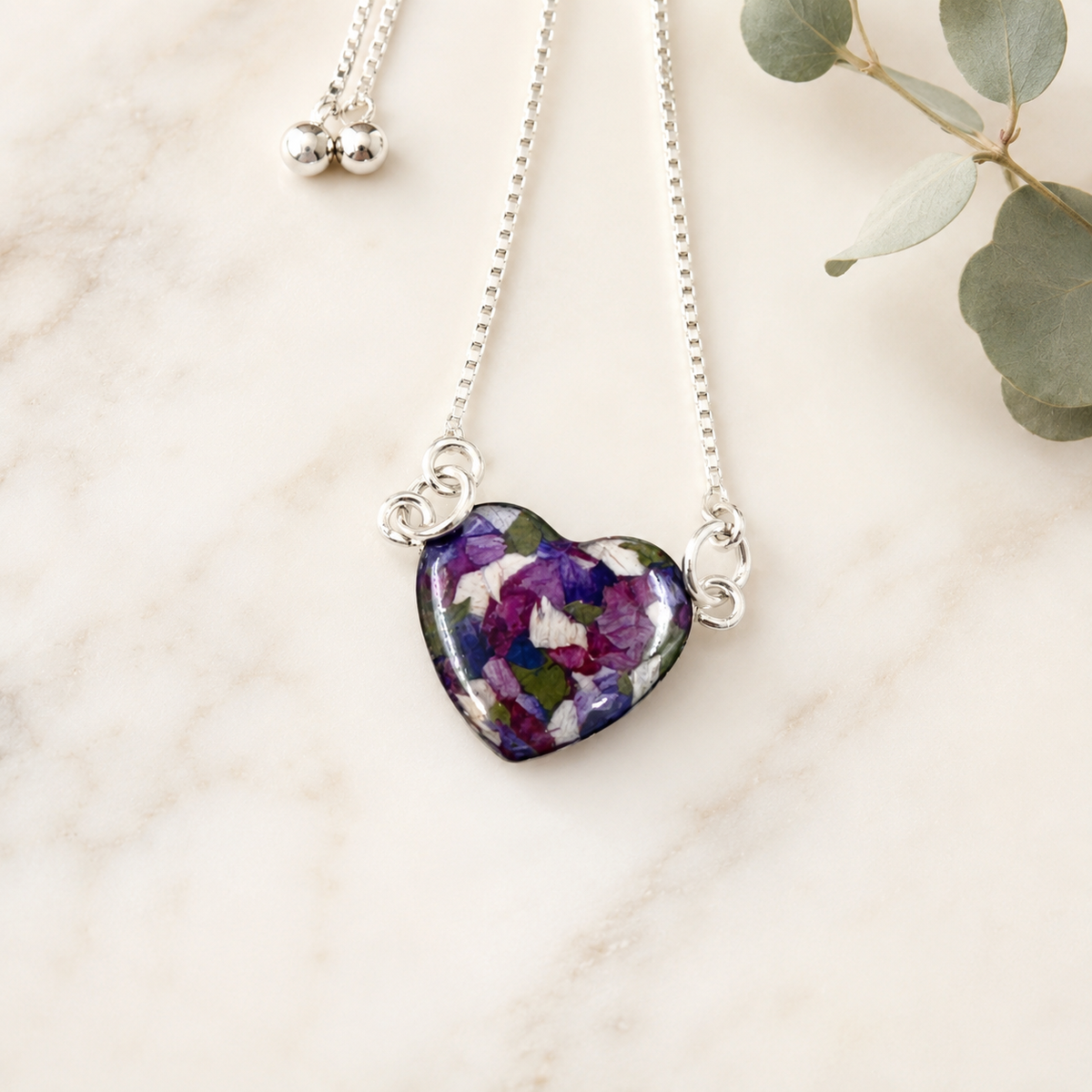 Demi Heart Memorial Bracelet with purple, white and green preserved flowers.