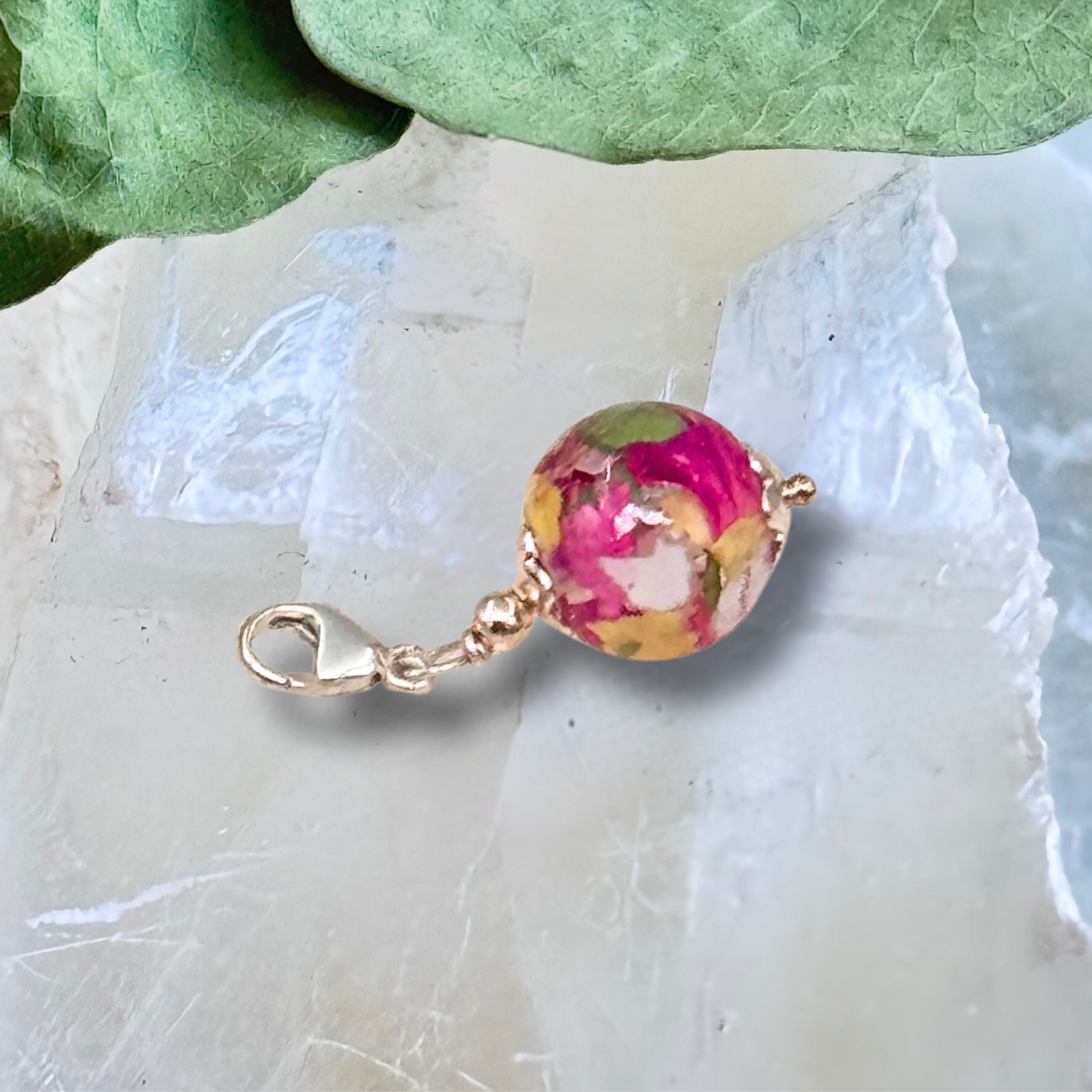 Round resin Bellabead add-on charm with preserved pink and yellow flower petals, handmade keepsake with silver clasp