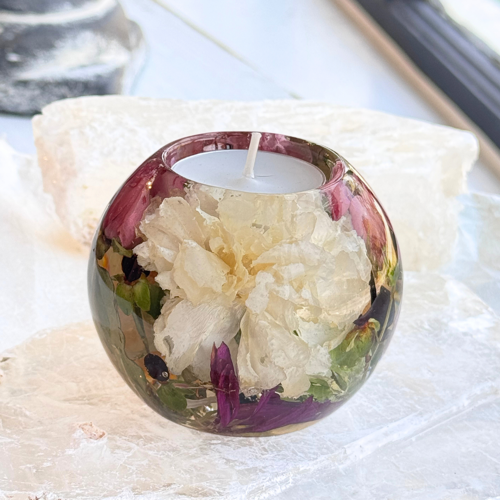 Flower preservation tealight candle holder with a white carnation and assorted freeze-dried flowers, handcrafted as a funeral flower keepsake.