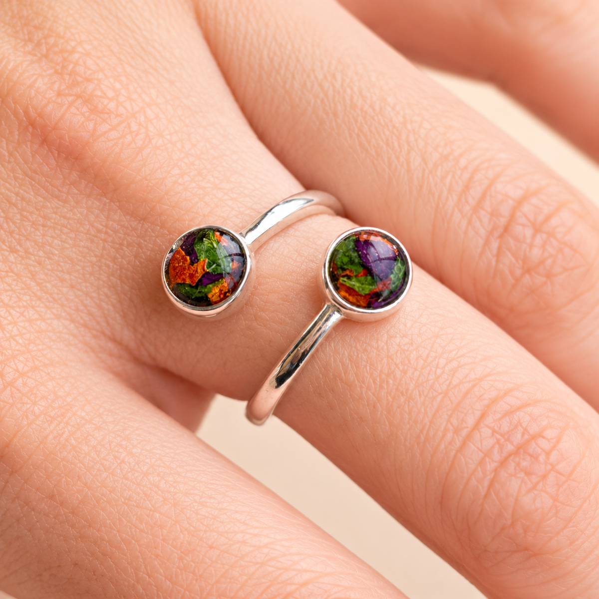 Model wearing Forever Grace Ring with orange, purple and green preserved flowers in silver
