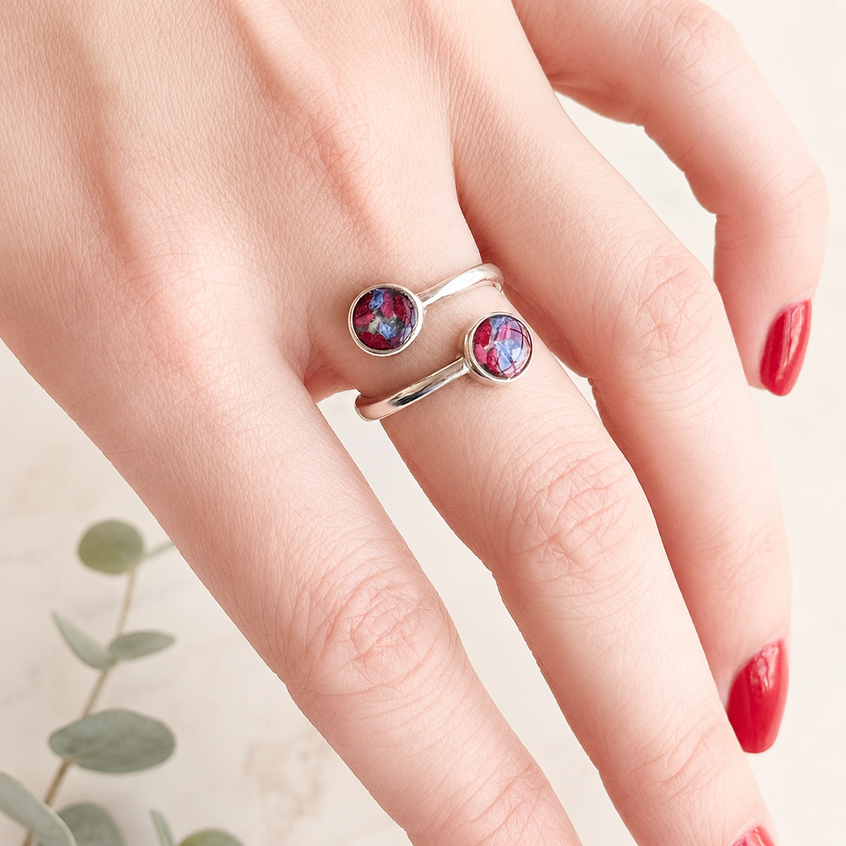 Model wearing Forever Grace Ring with pink and blue preserved flowers in silver settings.
